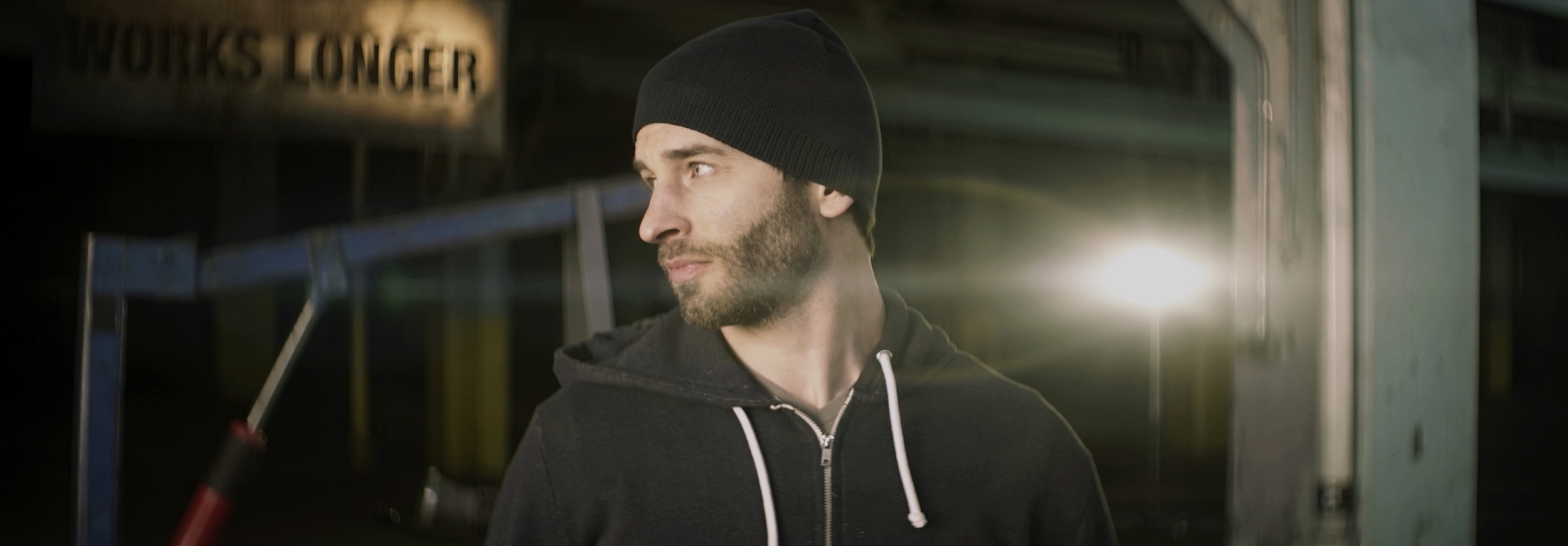 Lomo 50mm square-front anamorphic | Warehouse, Cleveland, OH. Fellow shooter and filmmaker William O'Boyle striking a pose here as a flare attacks his neck. Lighting instrument is a ETC Desire D40 daylight LED. Image captured wide open. Photo by Keith Nickoson.