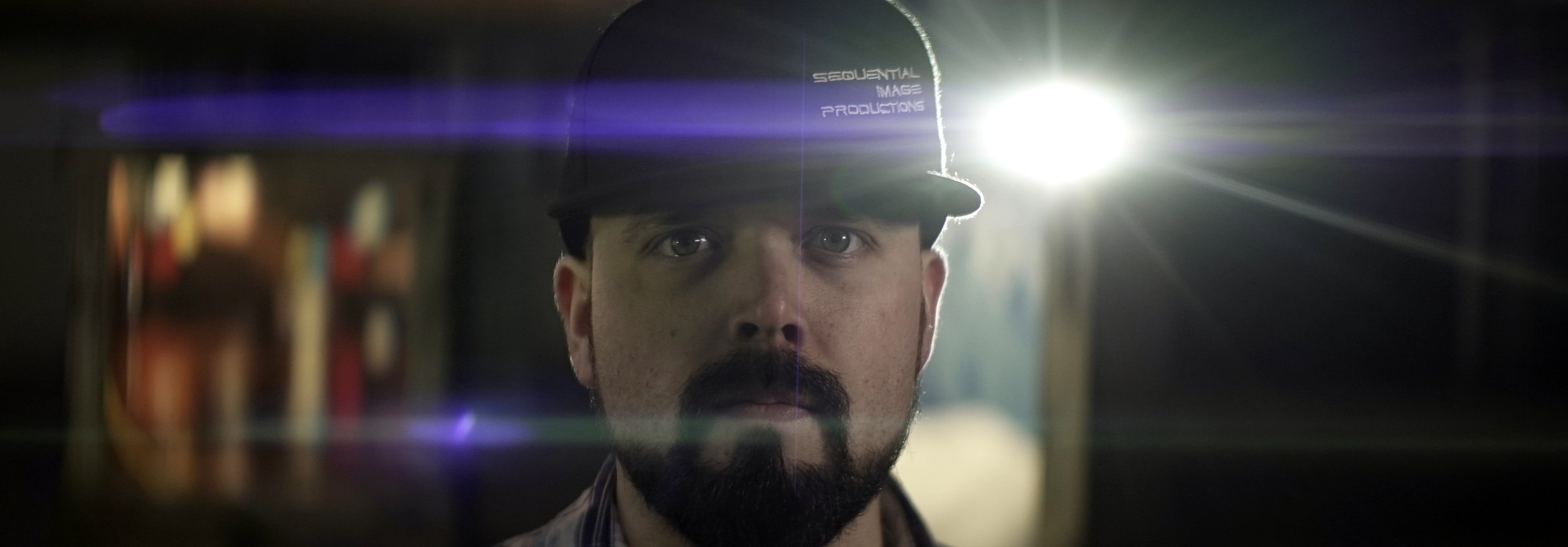 Lomo 100mm anamorphic lens | This beautiful blue flare was created by a Nitecore P12 flashlight. Notice that the contrast is retained here, as we can clearly see Ryan Keeper of Sequential Image Productions within the frame. Photo by: Keith Nickoson