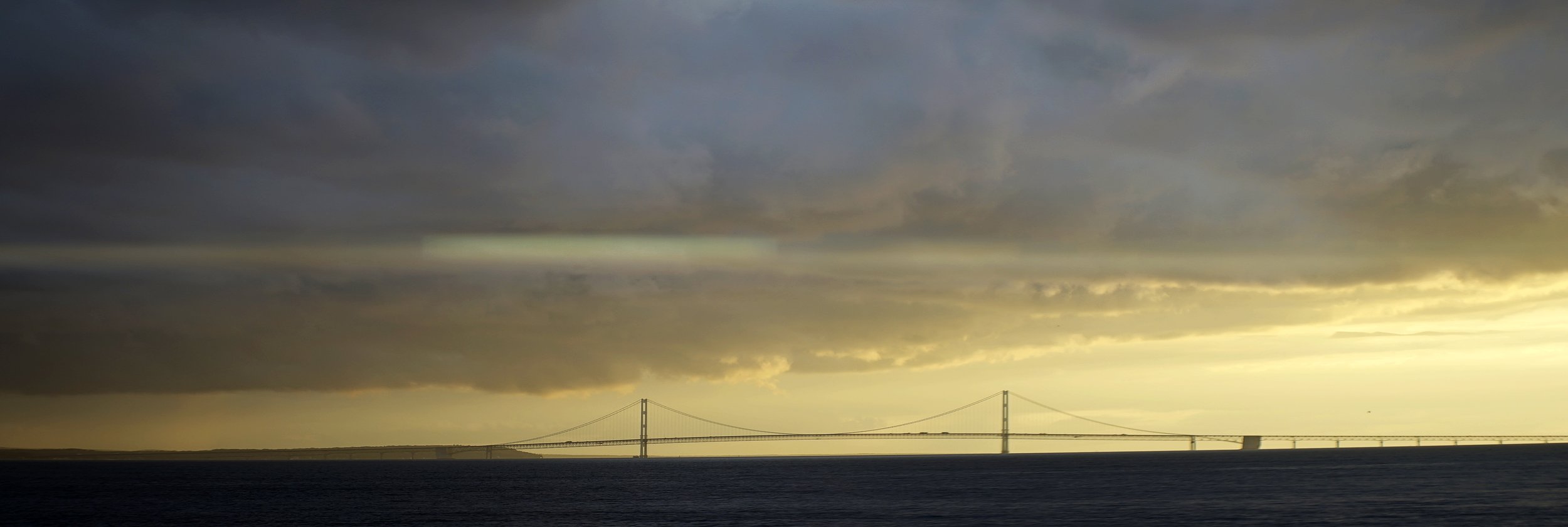Lomo 100mm anamorphic lens | A subtle streak can be seen through the center of this picture of the Mackinac Bridge in Michigan. The sun was just out of frame right, about fifteen minutes before sunset. Photo by: Keith Nickoson