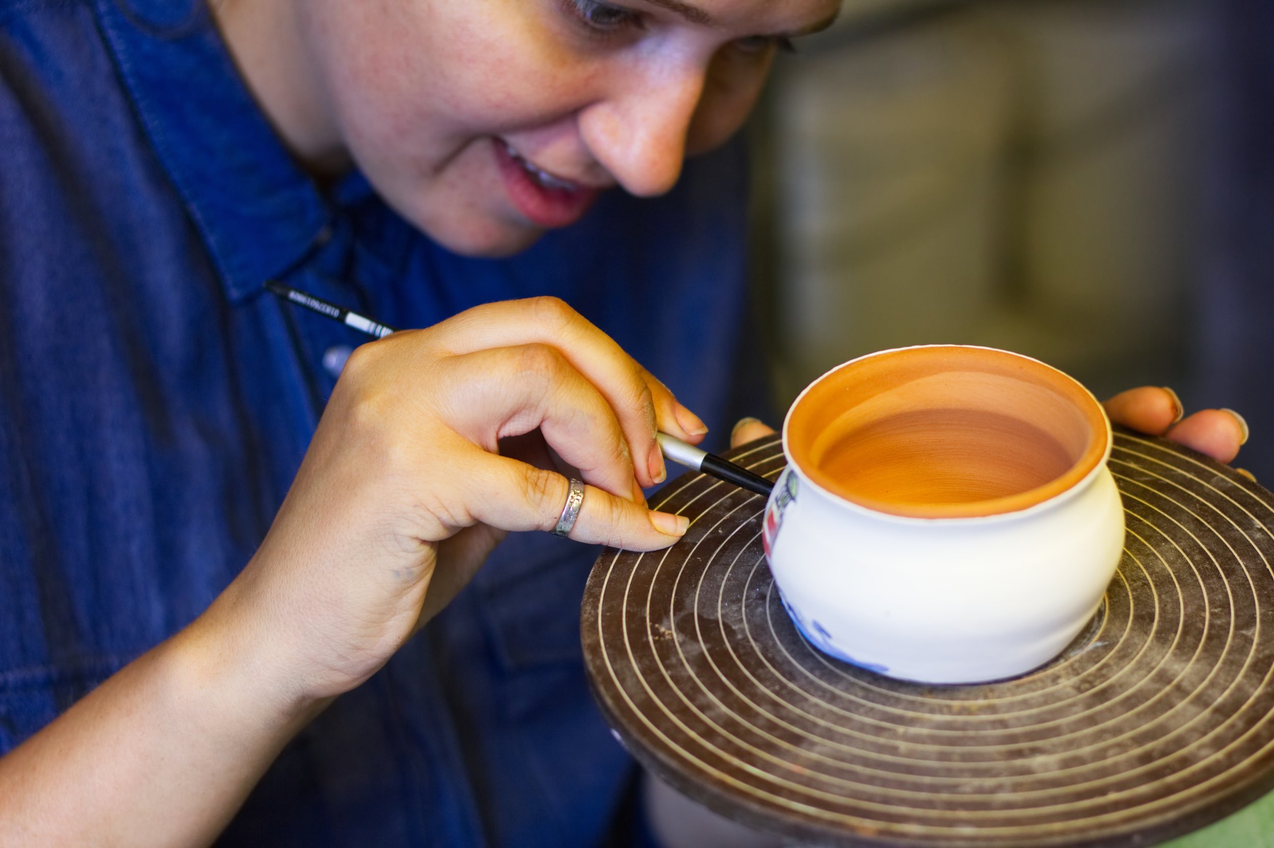 person painting pottery.jpg