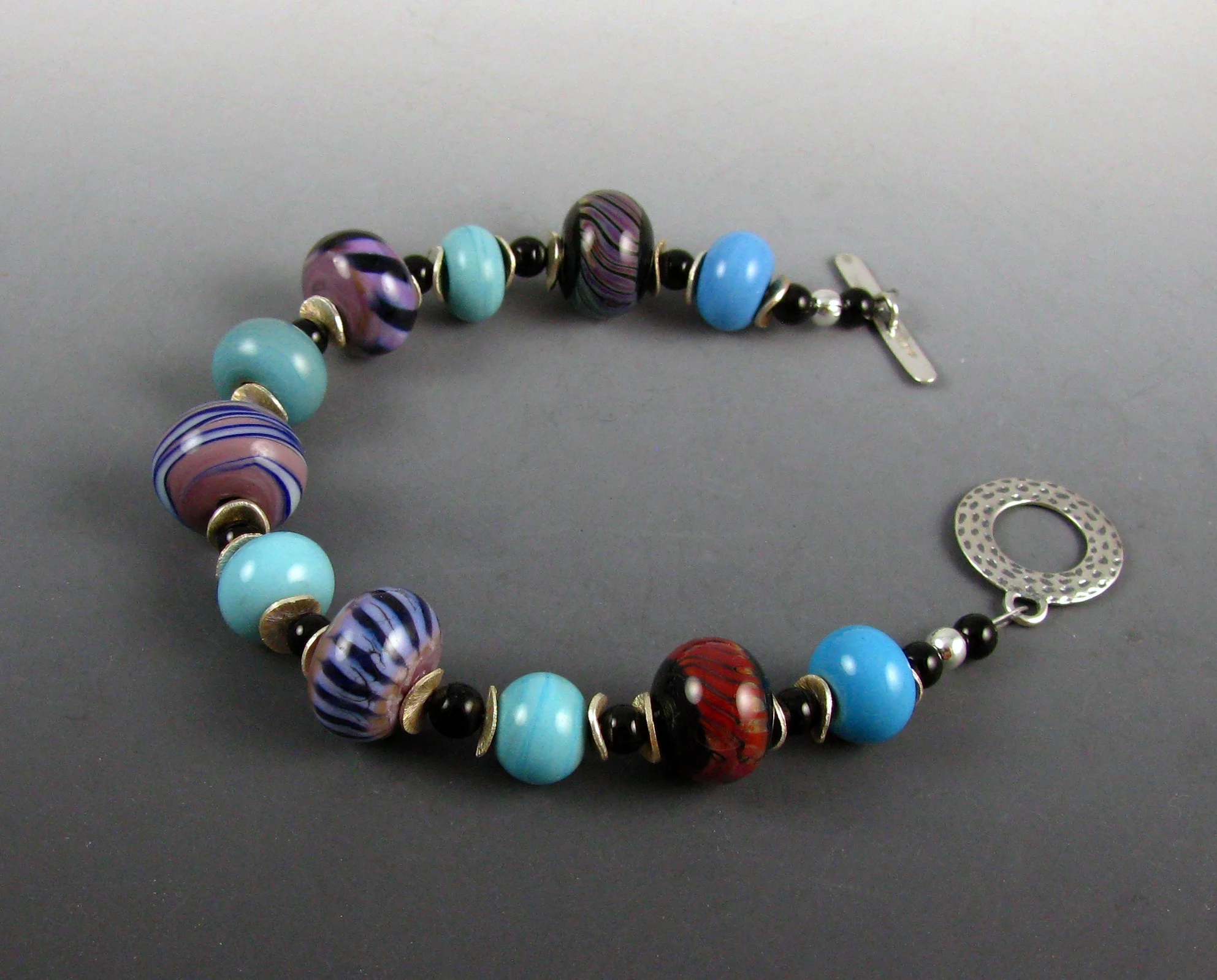 Purple, turq, red bracelet.jpg
