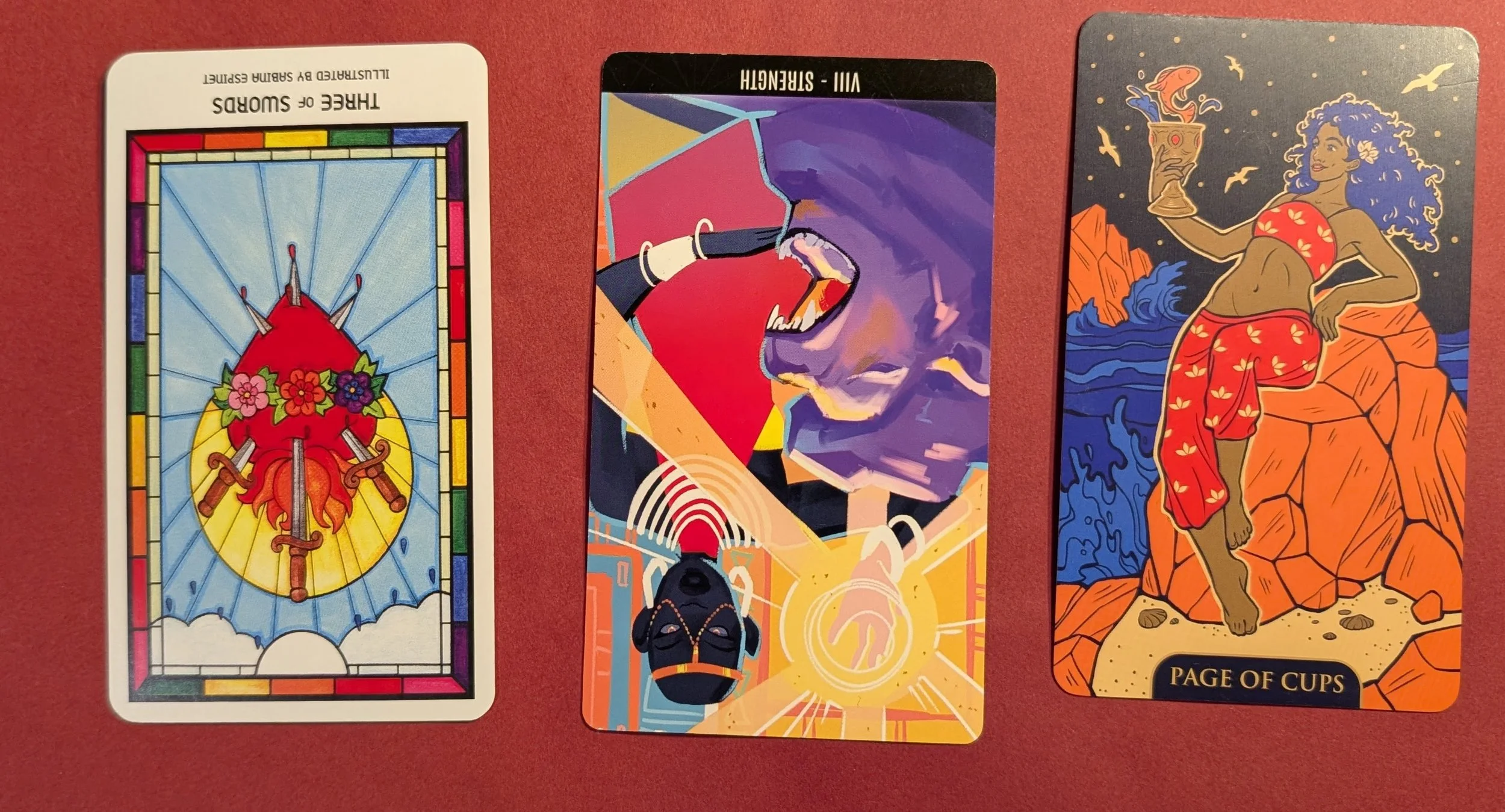 The Three of Swords, Strength, and the Page of Cups