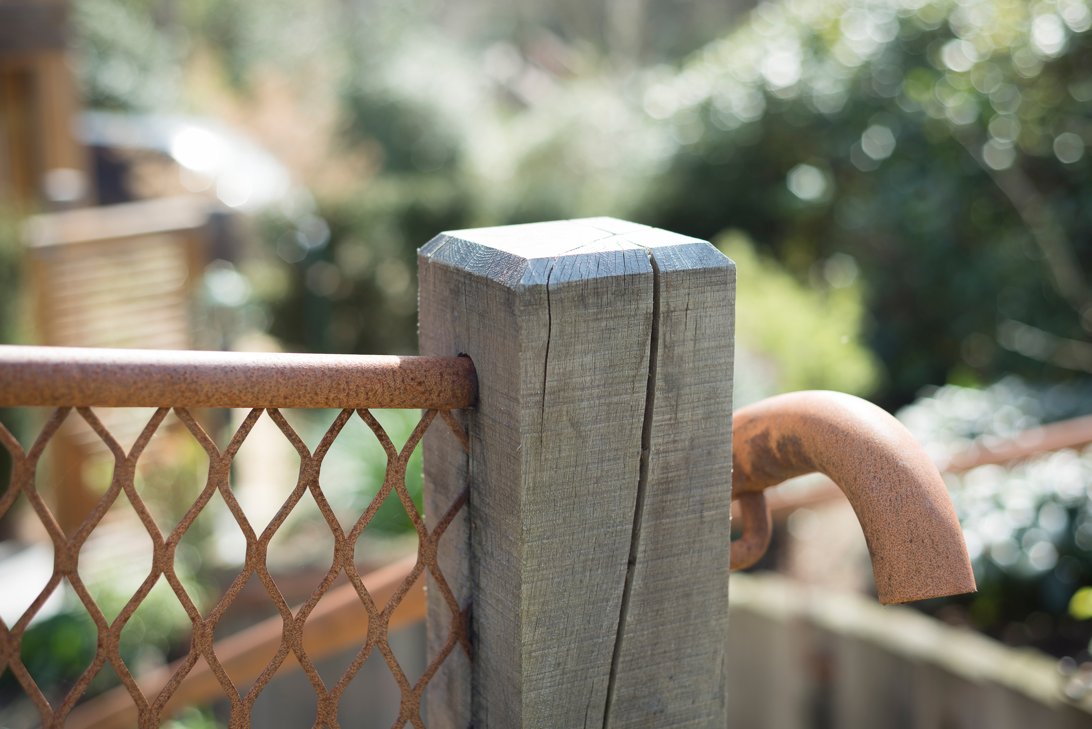 Weathered Oak Post with Rusted Mesh Fence and Hand Rail