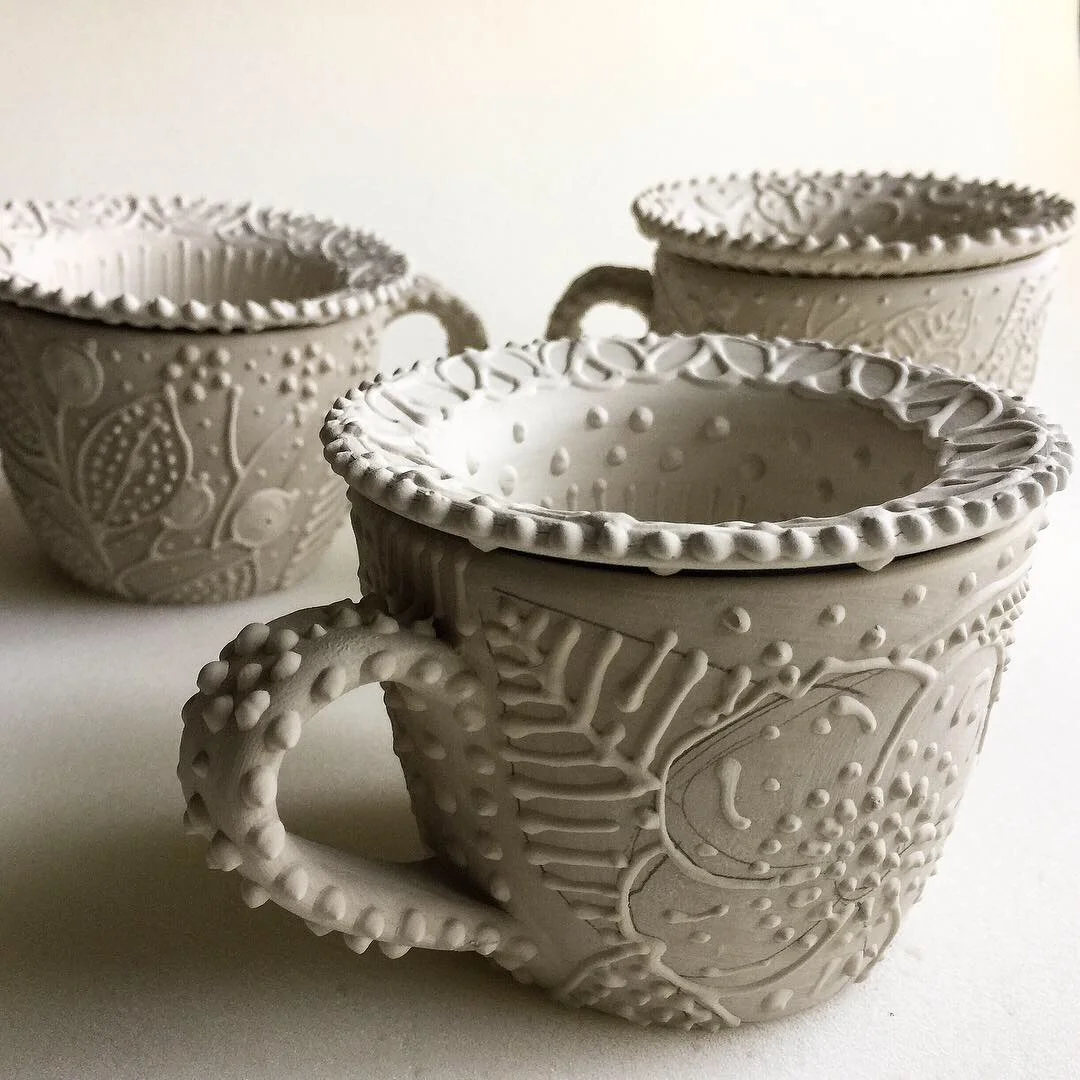 Teacups with loose leaf infusers in the works