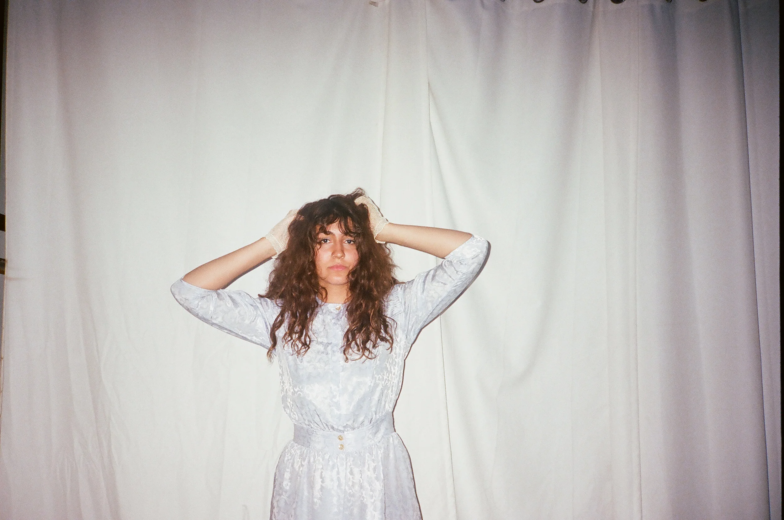 Sabrina wears her own vintage gloves paired with our dress, available here .