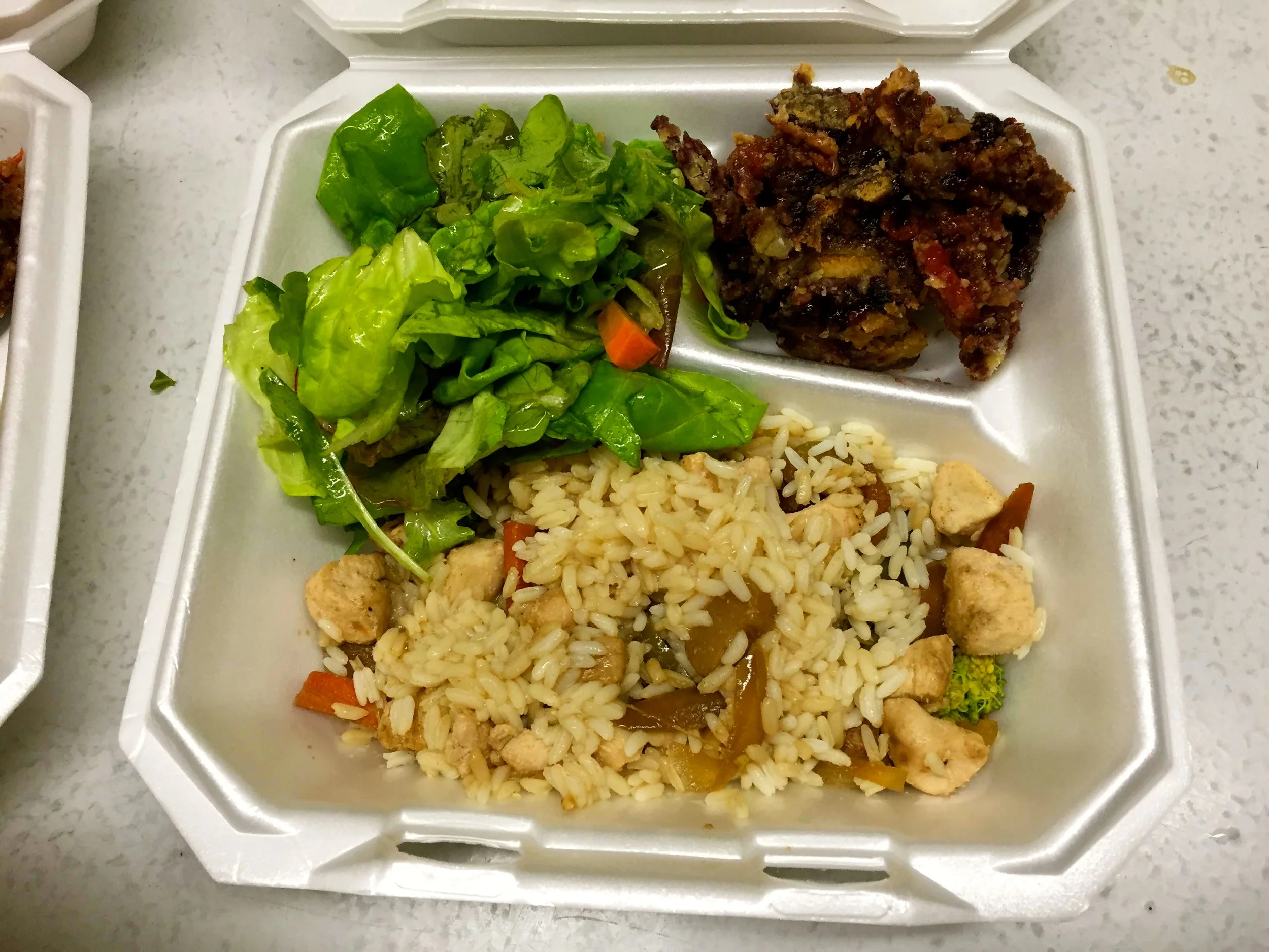 Leftover food is boxed up for those who pass through after dinner. 