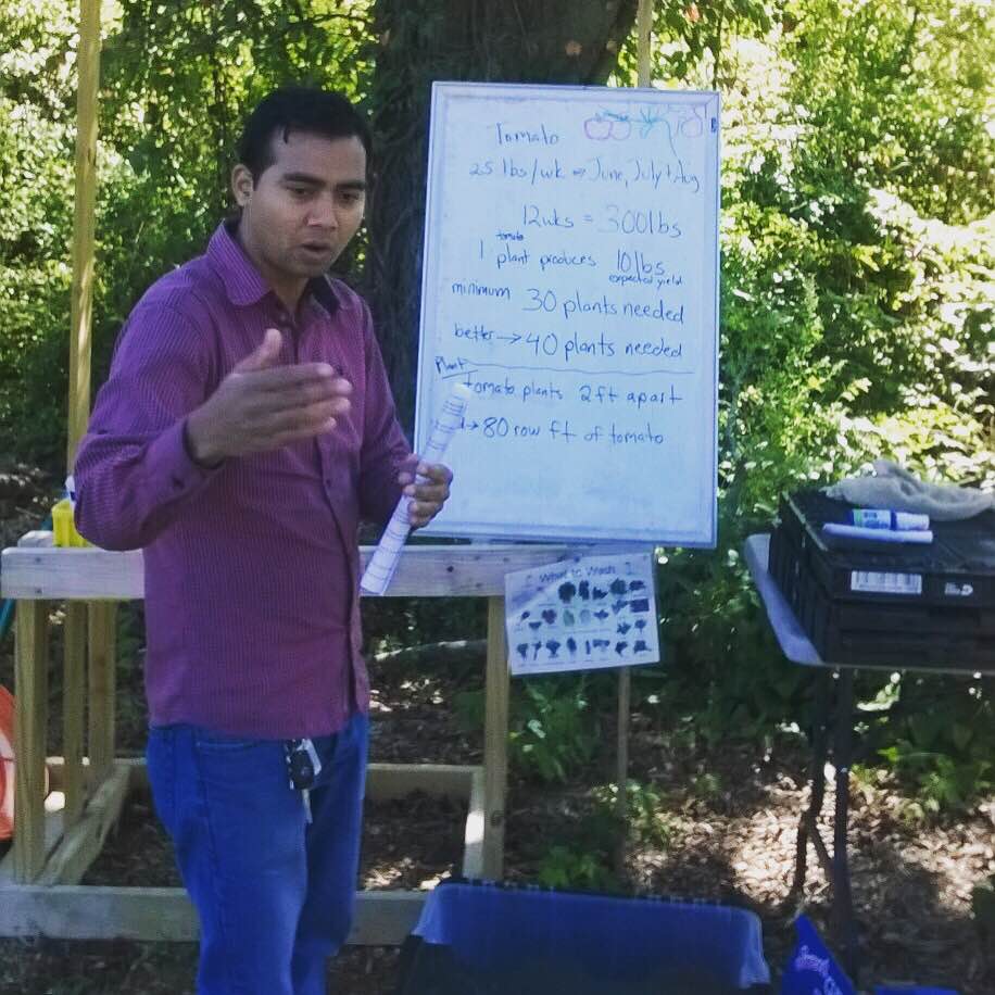 Siddi Rimal interprets during a training session with refugee gardeners. 