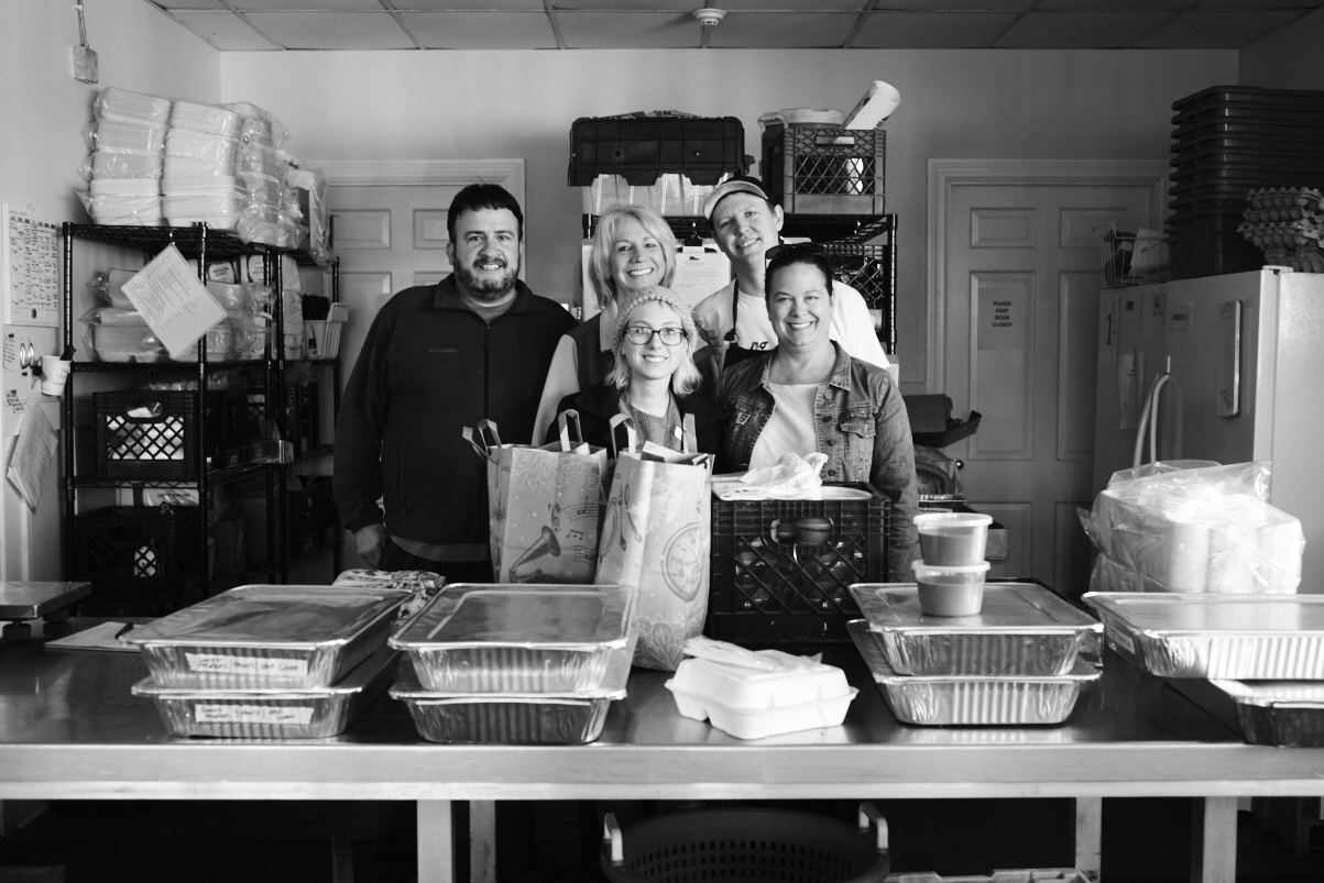 Owen handing off his meal to the truck delivery team. Photo by Danielle Atkins. 