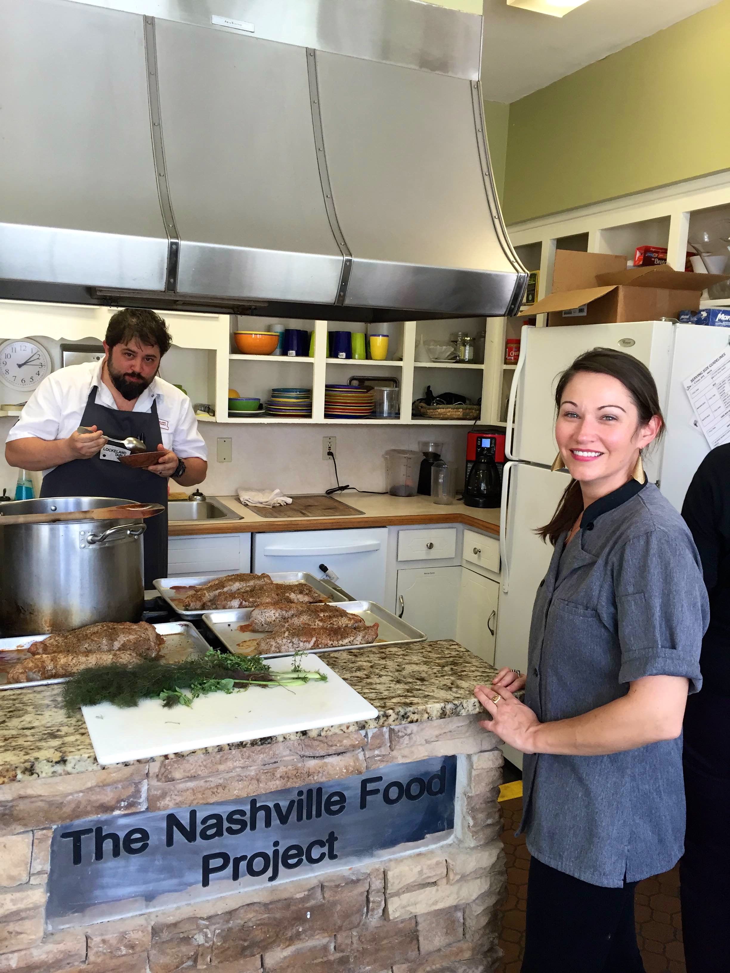 Chefs Holden-Bache and Miller pause to taste during the cooking process.
