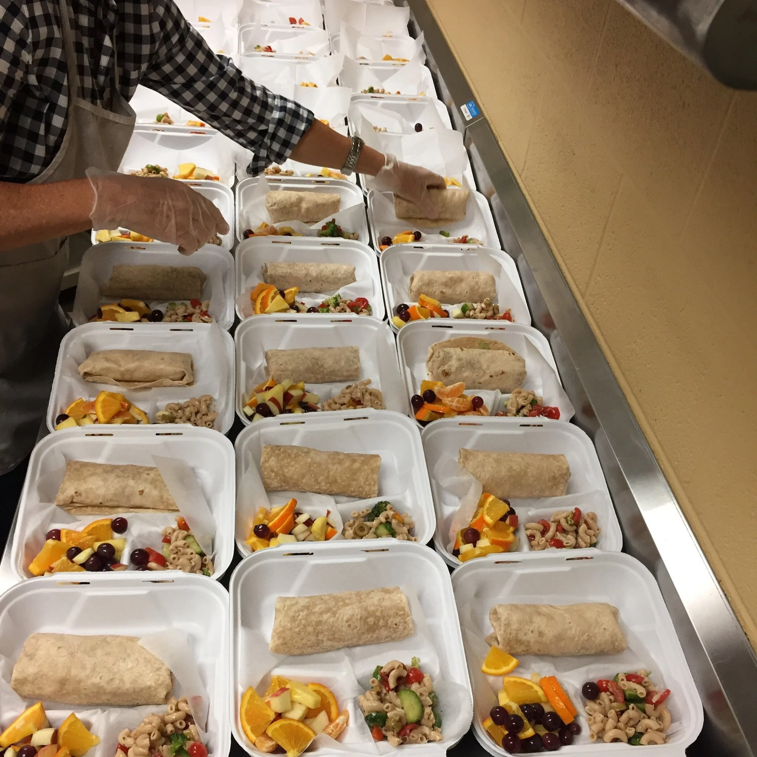 TNFP volunteer plating mobile meals at St. Luke’s Community House