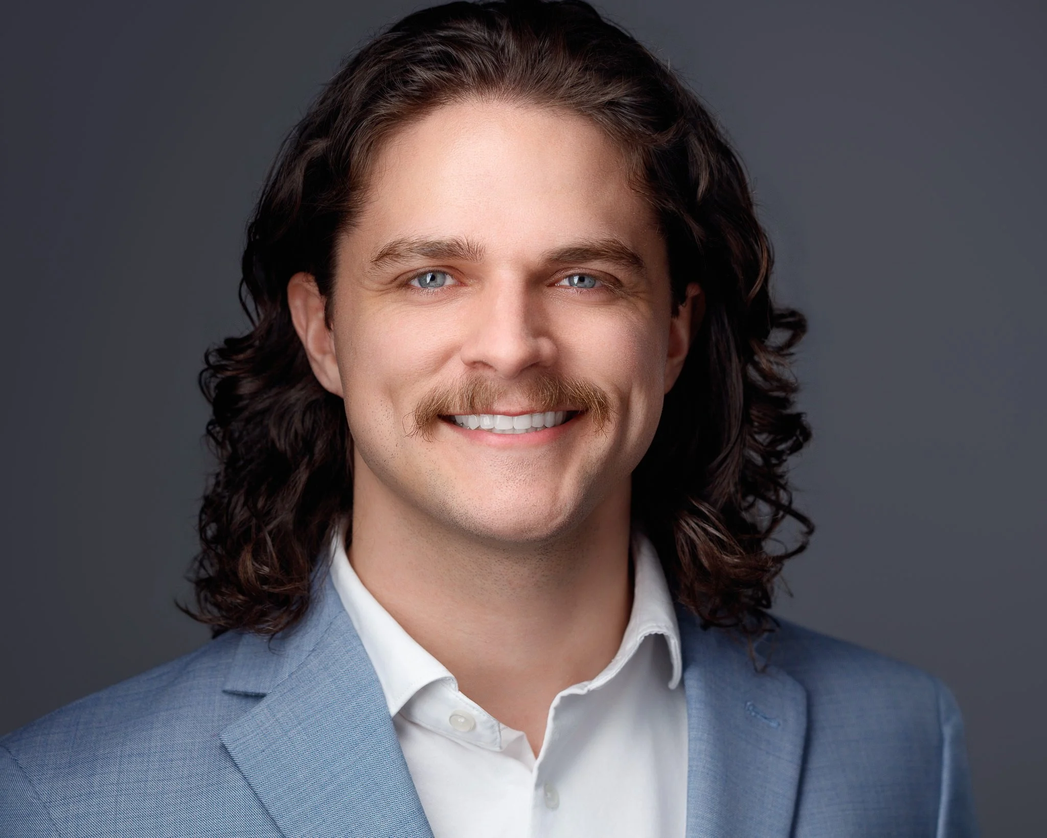 Friendly LinkedIn headshot of man in Denver with natural smile and approachable expression