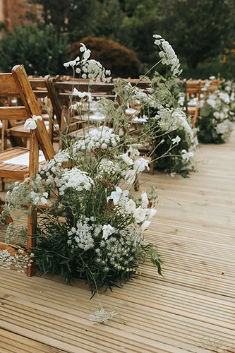 wild meadow style aisle flowers with summer wild ammi and garden roses for a elegant wedding in London