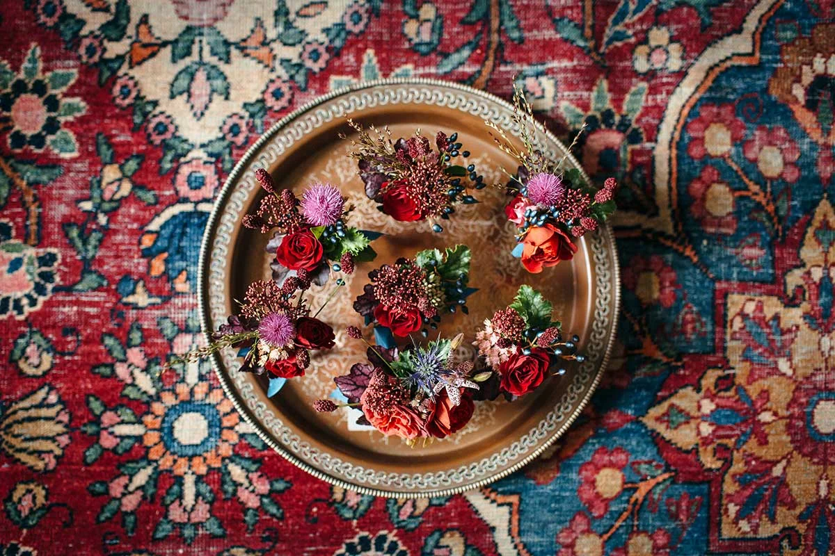 unique red and caramel wild flower buttonholes for a devon wedding in autumn