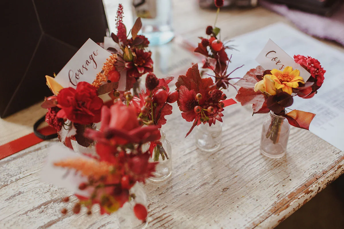unique red and yellow buttonholes with wild flowers and berries
