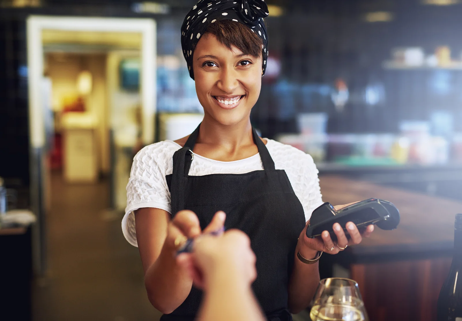 Smiling Waitress Taking A Credit Card