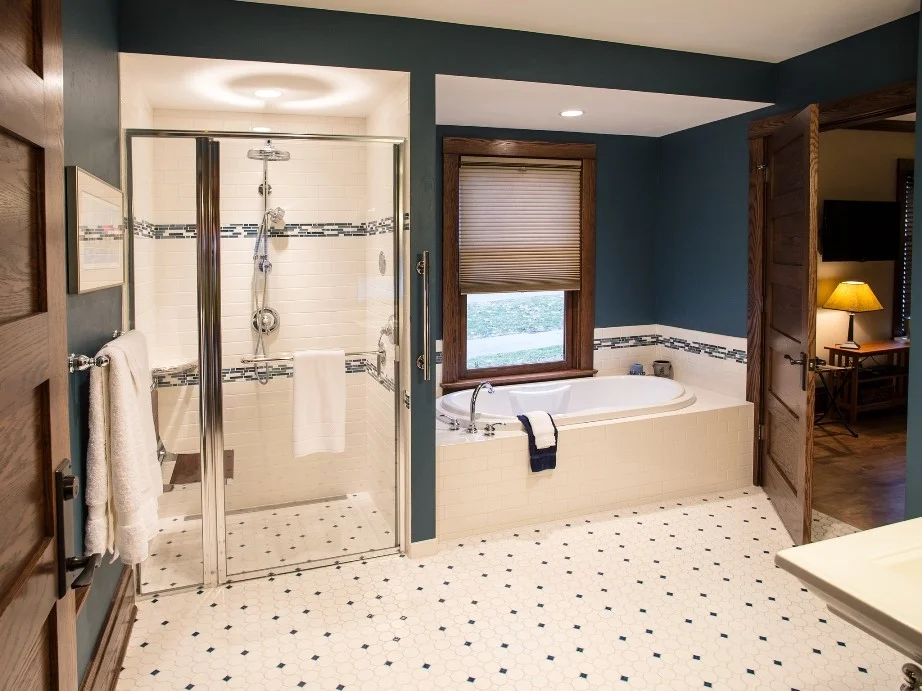 Blue and White Tiled Mendota Suite Bathroom Has Jetted Tub and Roll-in Shower with Drop Down Seat and Multiple Shower Heads.jpg