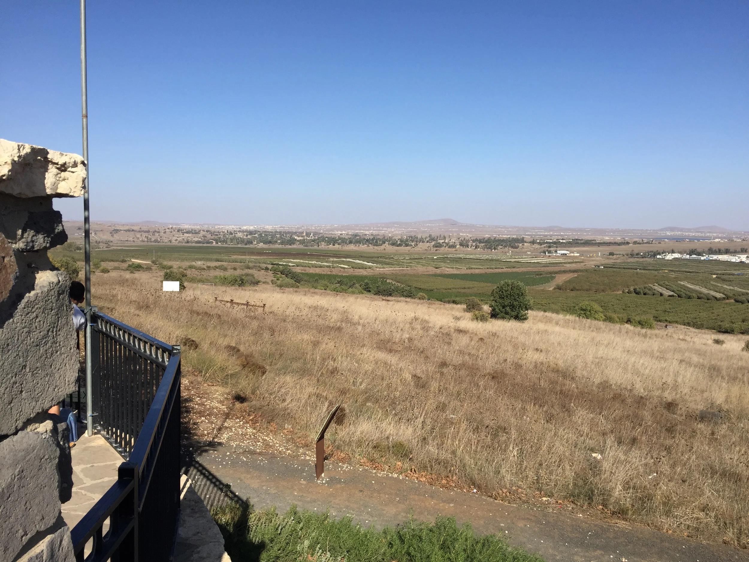 Damascus lies in the distance. Most likely, Saul was somewhere in this area during the events of Acts 9. The white buidings on the right are a UN complex. Everything behind the white buildings is in Syria. The line of trees in the background are in Syria. There is a gray fence marking the border.