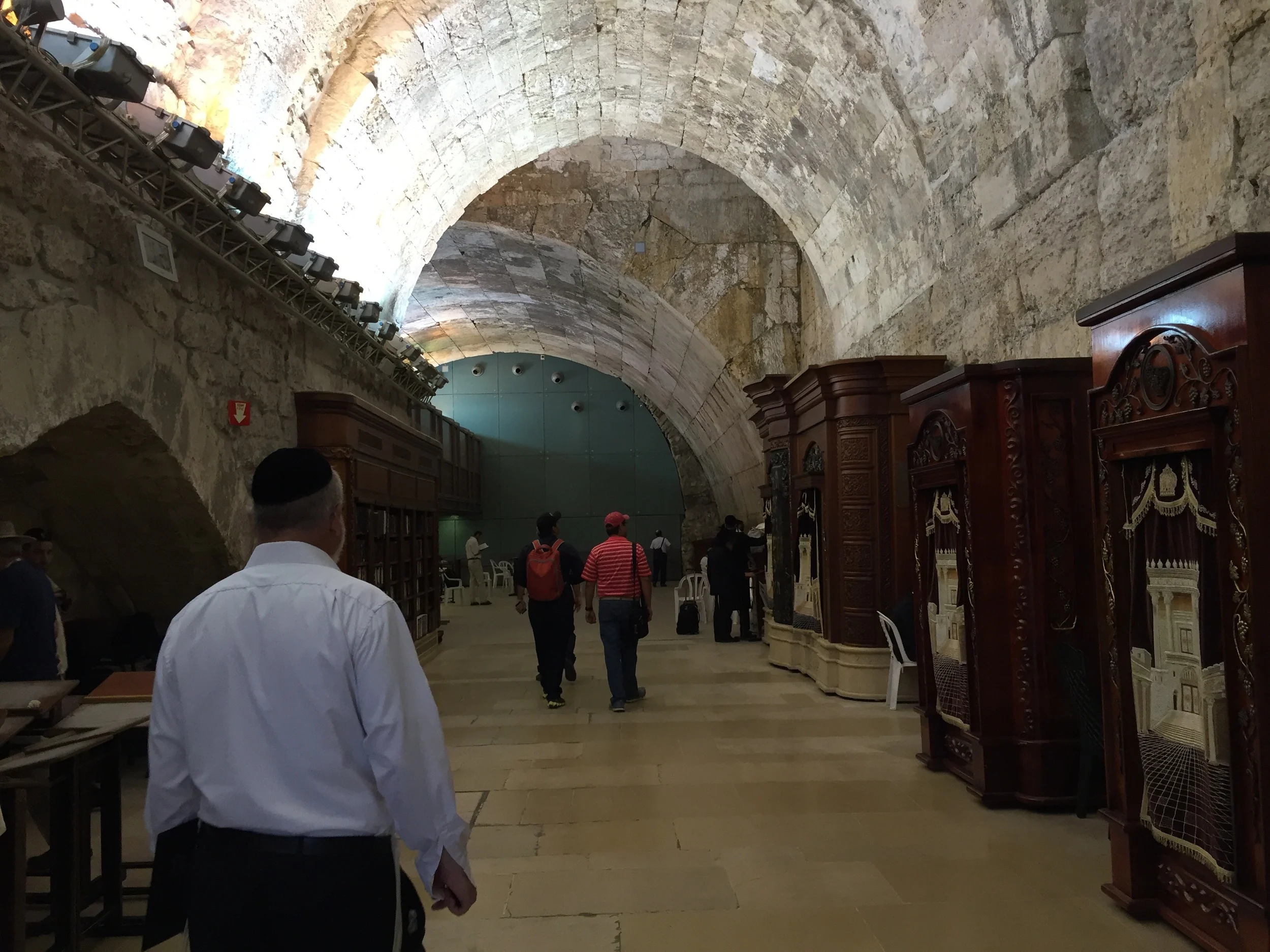 At the northern end of the men's section of the Wailing Wall, there is an arched doorway that leads to a bookstore. The wall of the bookstore is actually a continuation of the western wall! The last arch in this picture, the darker one next to the green wall, is called Wilson's Arch. It is named after the man who found it. It is one of the paths that used to lead up to the Temple Mount in the days of the first century. It is a unique and beautiful store. Because it is a continuation of the Wailing Wall you will see Jewish men pull chairs up to wall in order to sit and pray. Because it is in the men's section of the wall, women are not allowed in the bookstore.