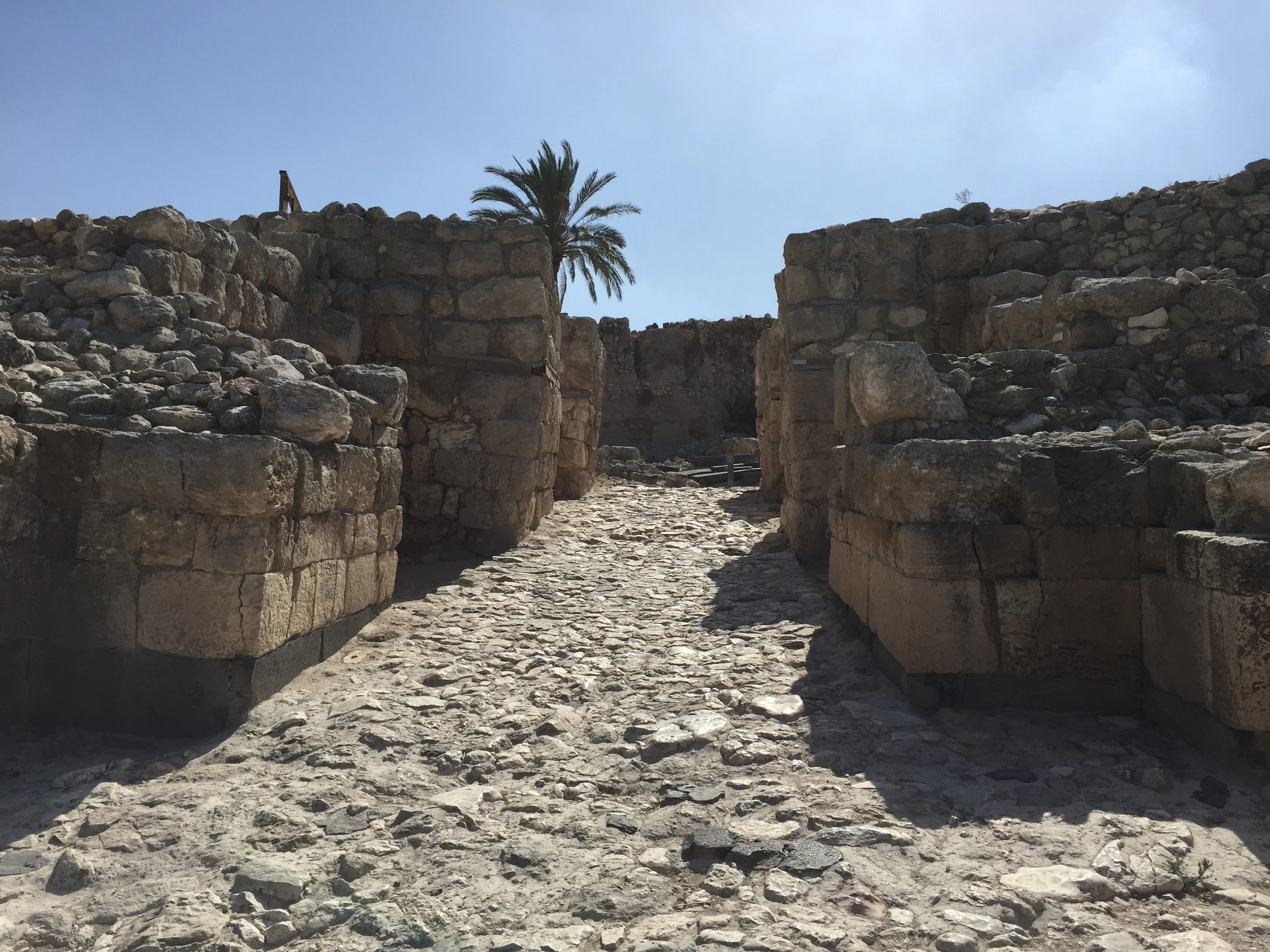 Facing the entrance of the city gate from outside the walls.