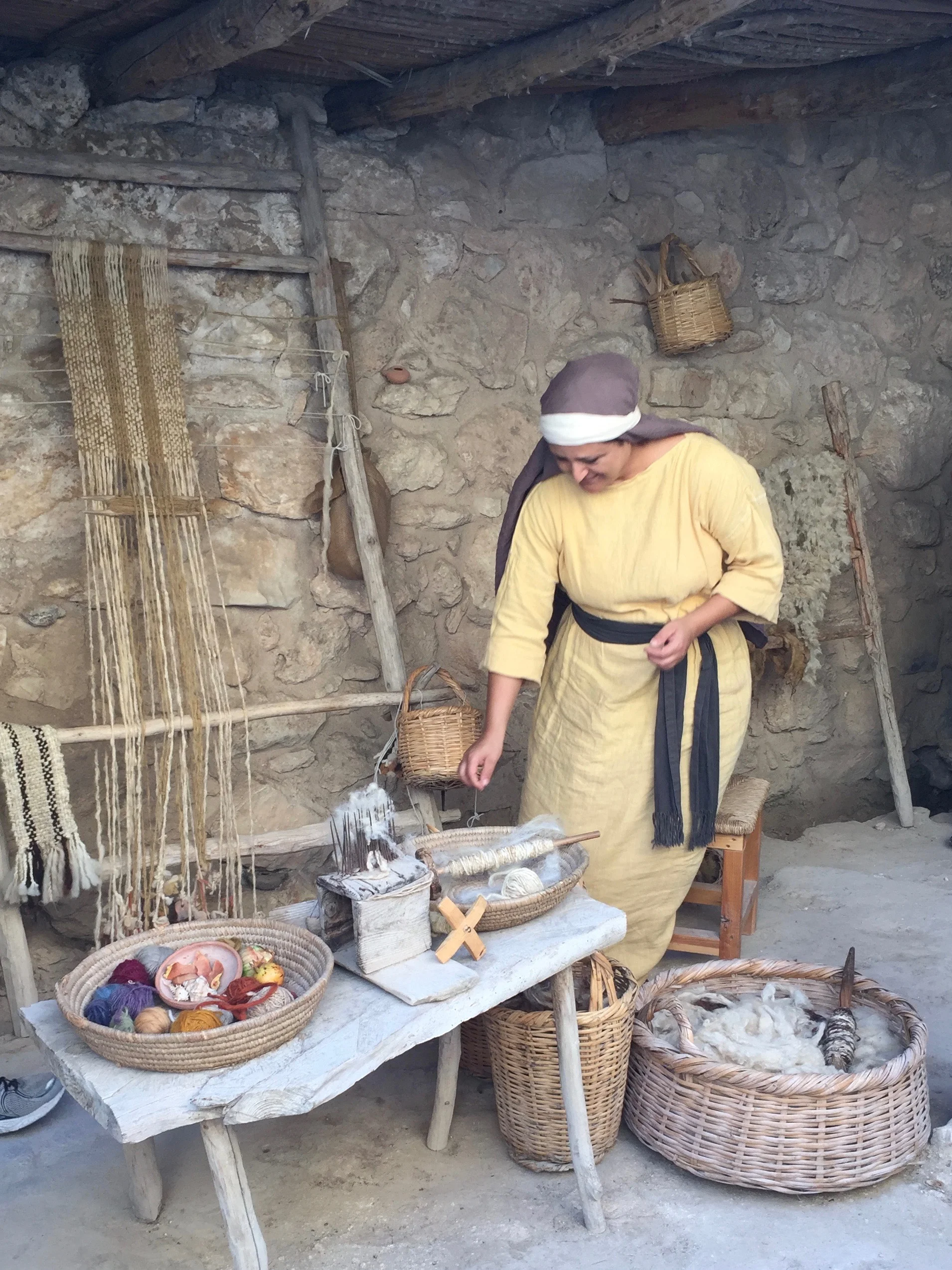 The weaver showing us how she spins yarn.