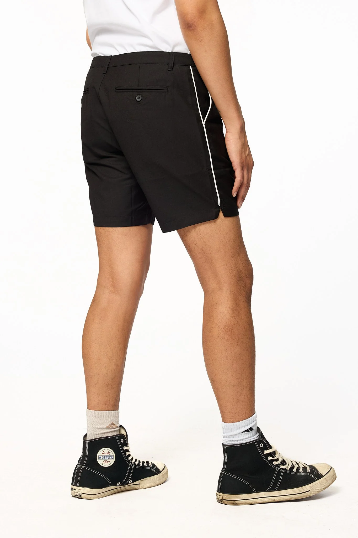 Black piped shorts angled back view showing piping and fit through leg
