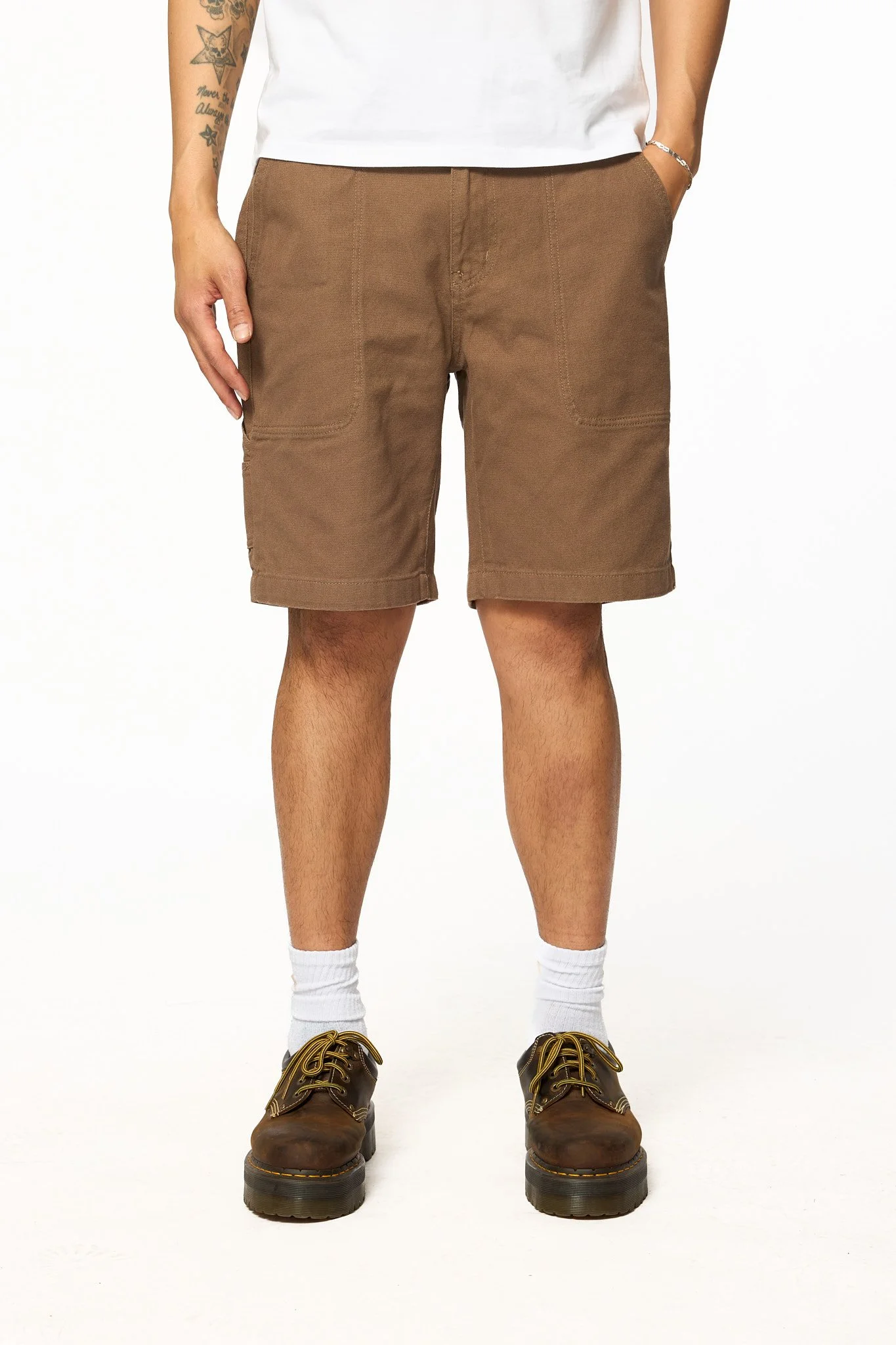 Brown canvas work shorts front detail showing pocket construction and stitching