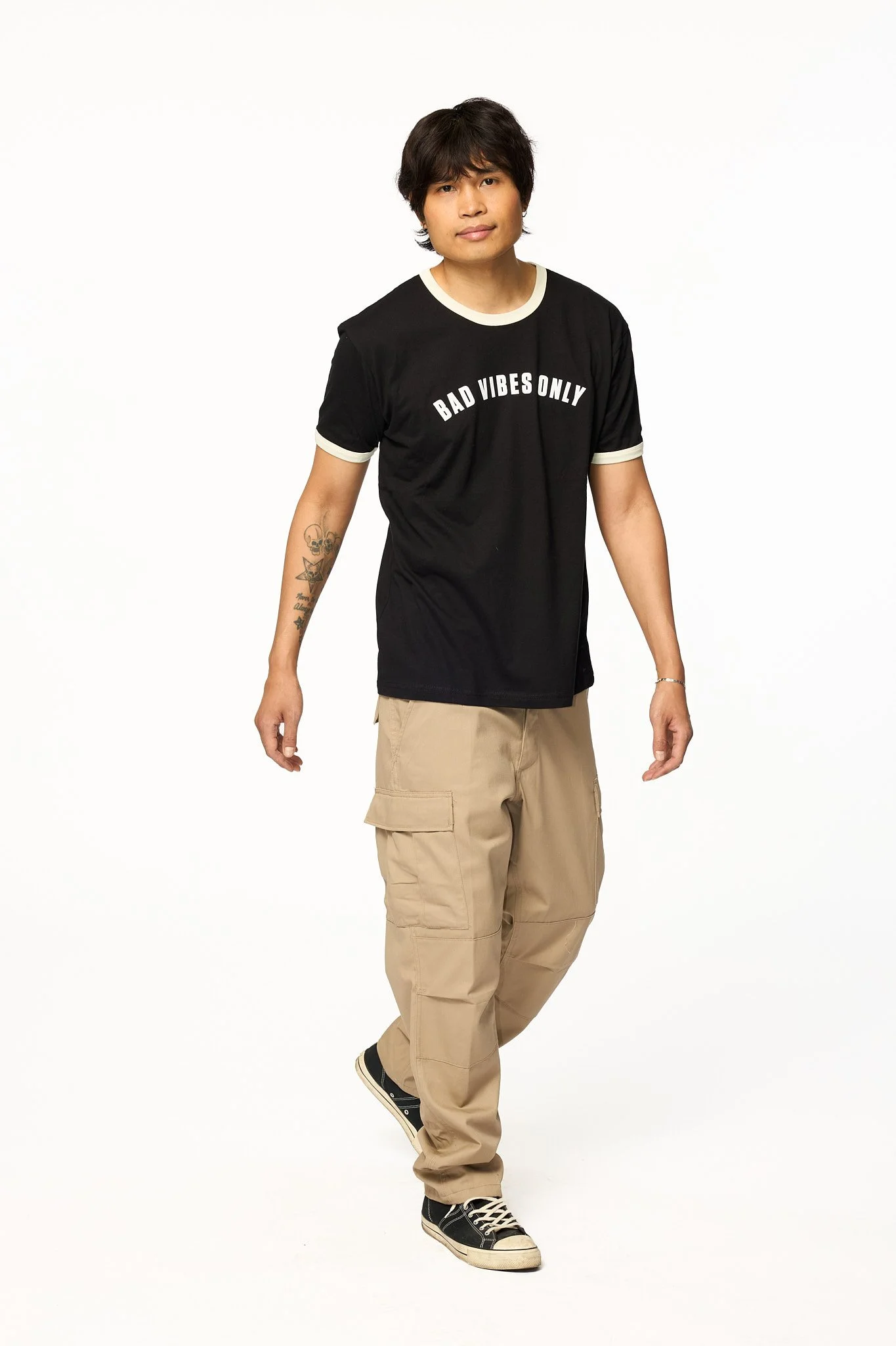 Khaki solid cargo pants relaxed fit front full body view with white black t-shirt walking
