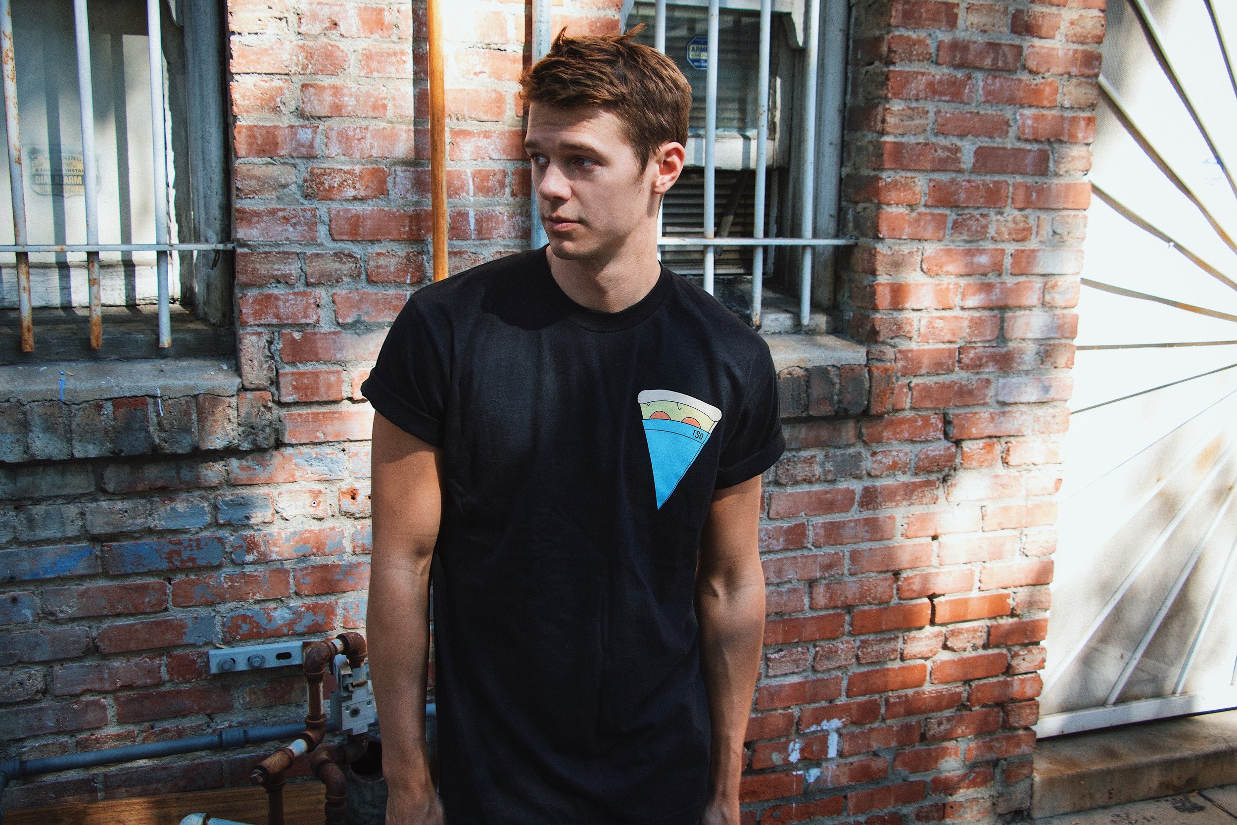 Faux Pizza Pocket Unisex Crewneck T-shirt. Available in Black and White