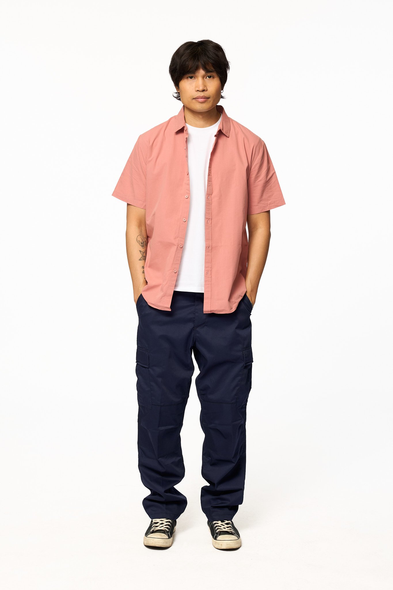 Navy solid cargo pants relaxed fit front full body view with pink button up shirt