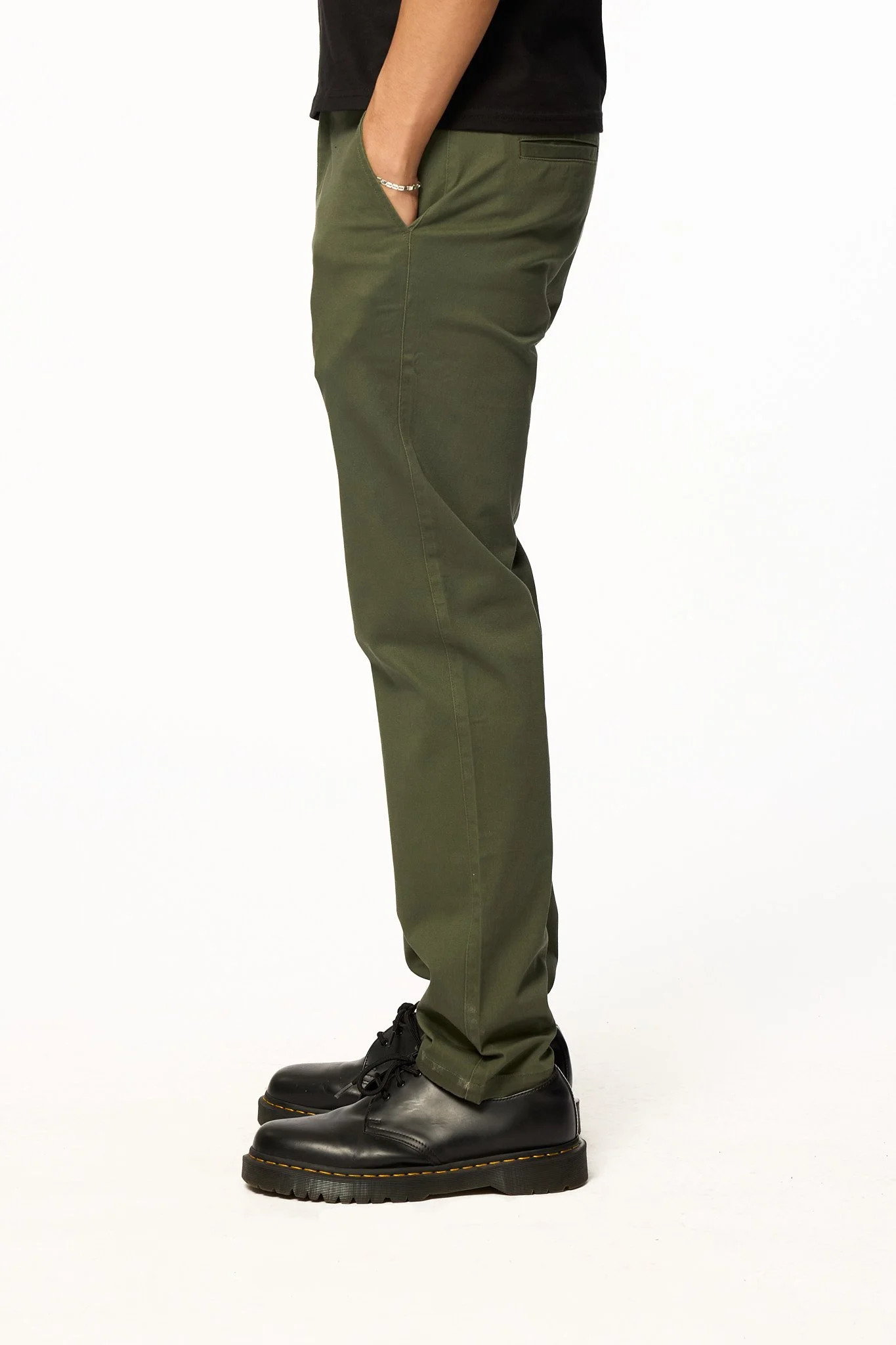 Green straight-leg pants side view with black shoes