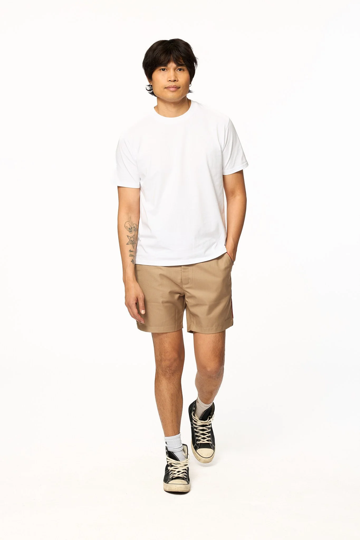 Khaki piped shorts full body walking shot with relaxed fit and piping detail