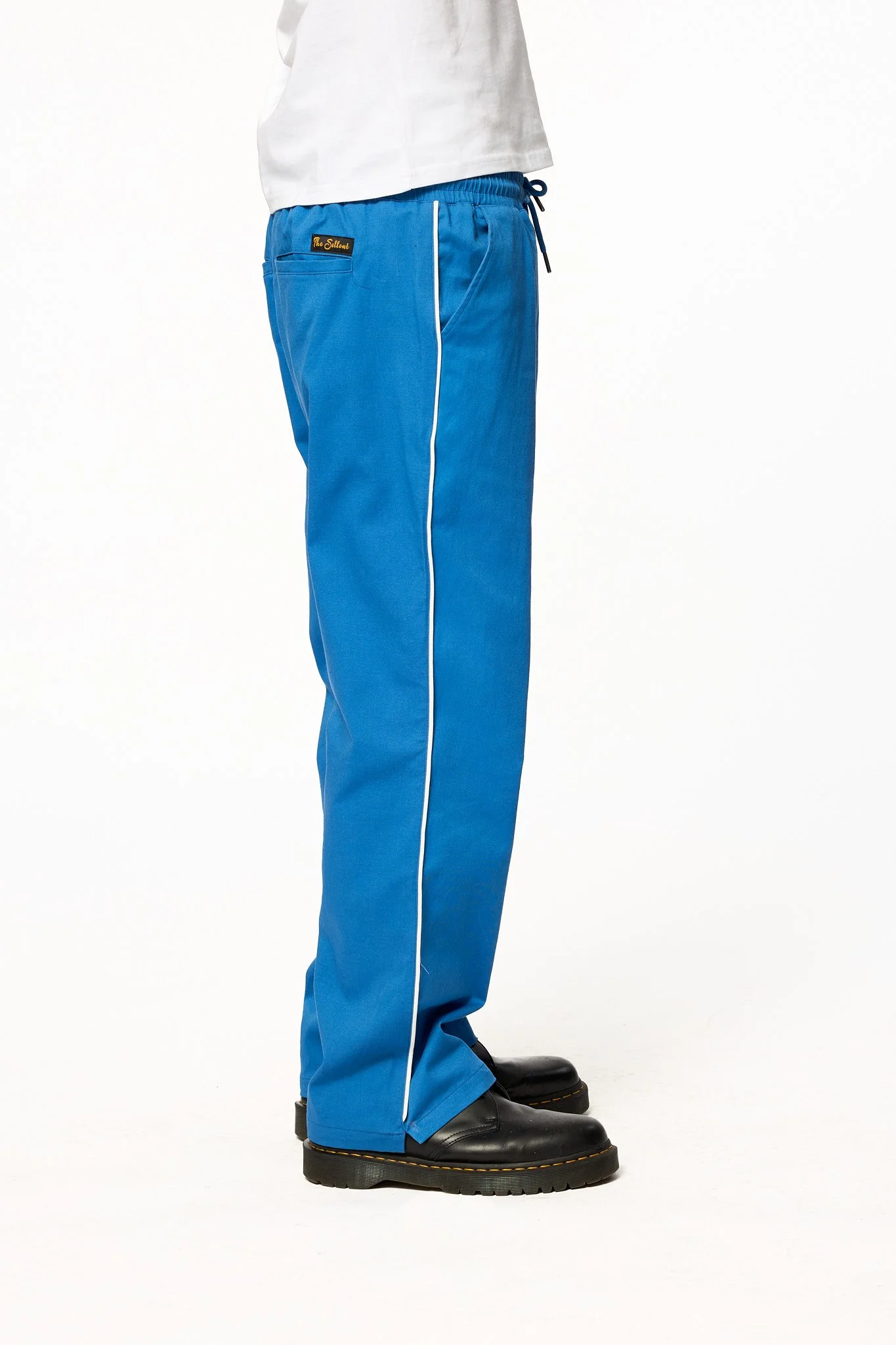 Side view of royal blue piped pants by The Sellout