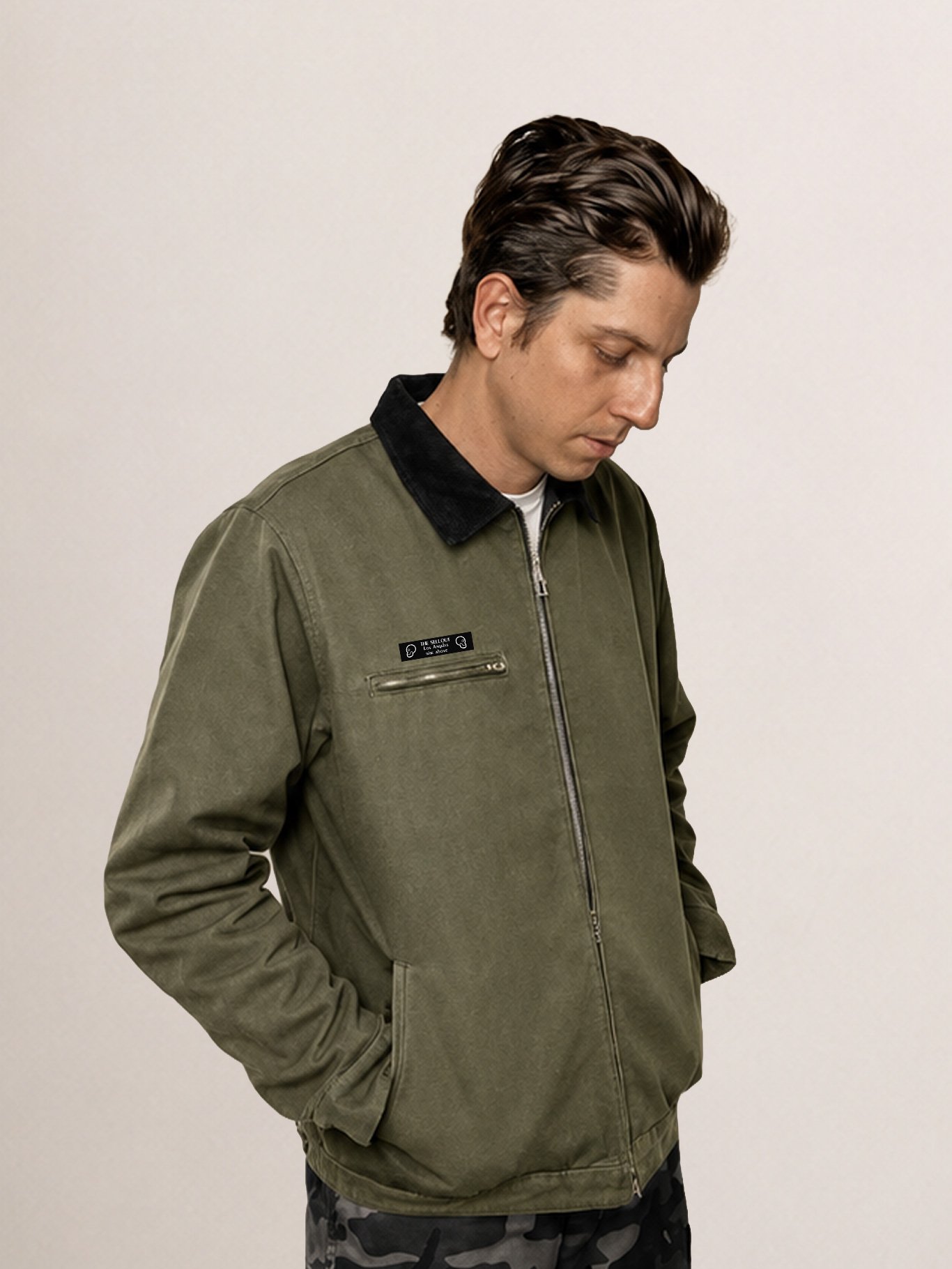 Model wearing The SellOut green canvas collar jacket with black corduroy collar for the Shop Jackets collection.