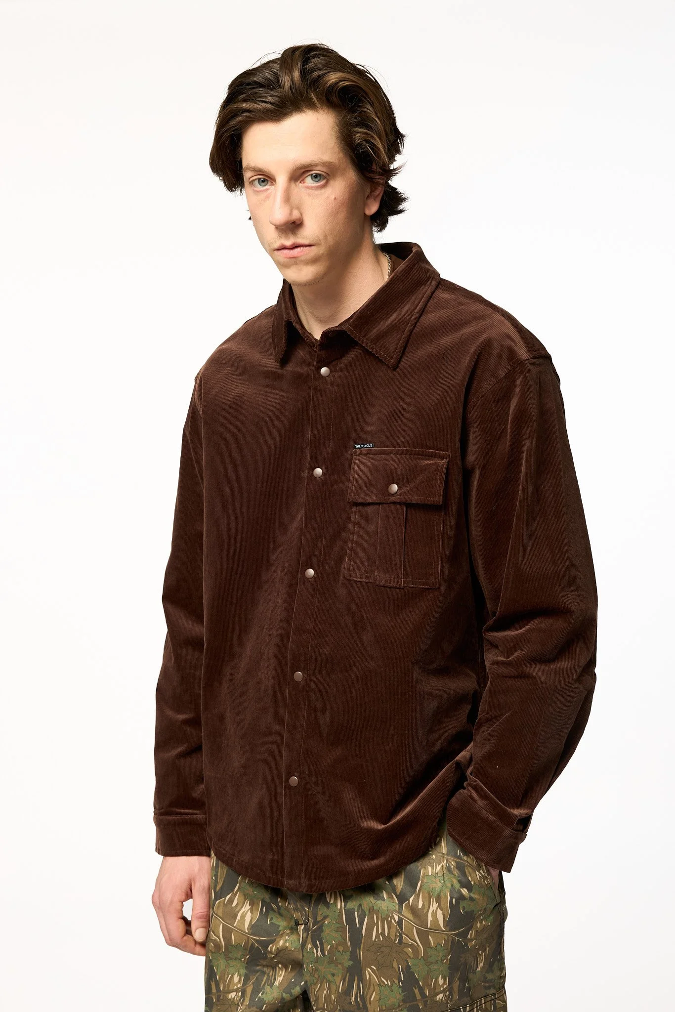 Oversized brown corduroy shirt jacket side 3/4 view showing relaxed fit