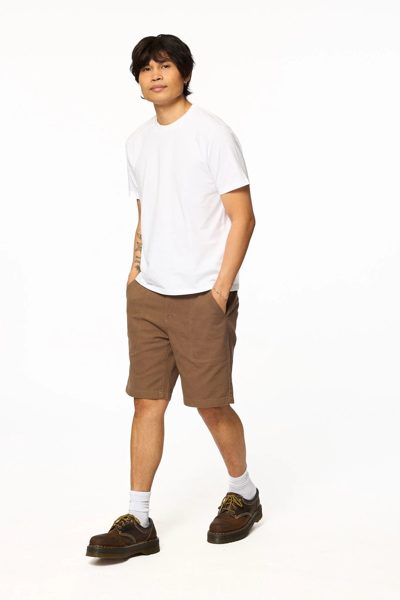 Brown canvas work shorts by The SellOut full body walking view showing relaxed fit