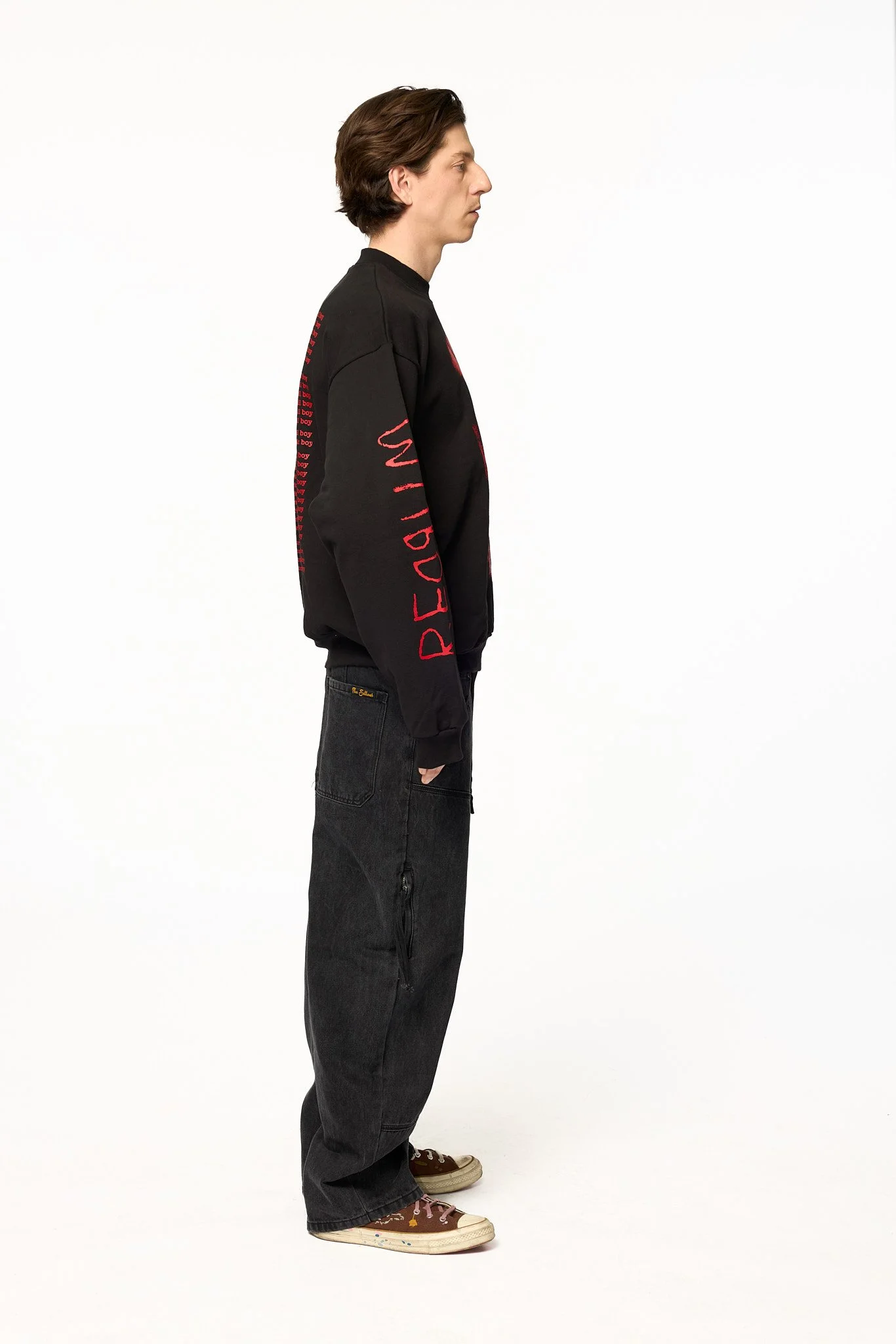 Black The Shining crewneck sweatshirt side view showing red text graphic on sleeve