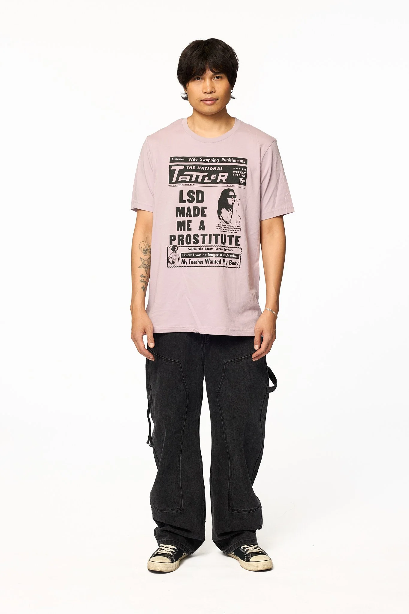 Pink Tattler graphic t-shirt front view showing tabloid style print and relaxed fit
