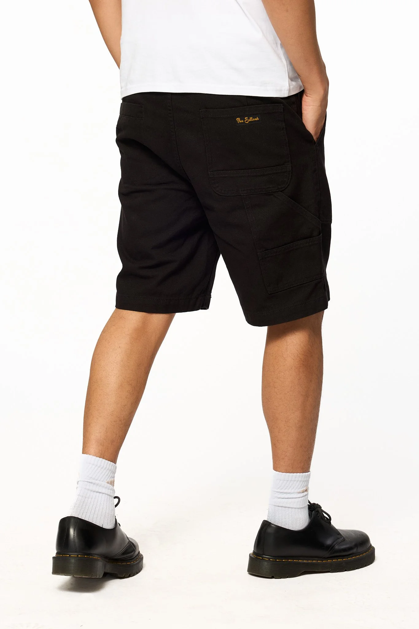 Black canvas work shorts back detail showing utility pockets and stitching