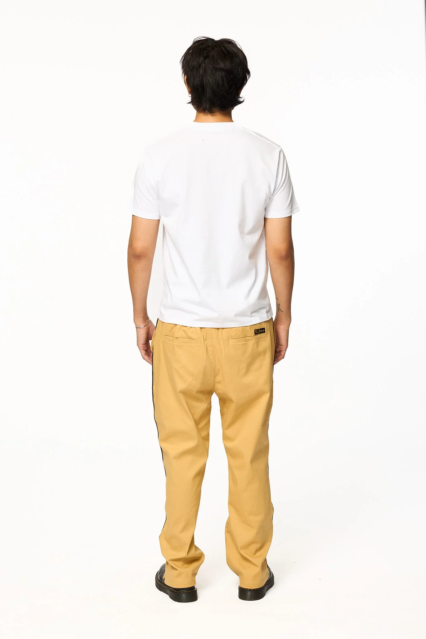 Khaki piped pants by The SellOut back view showing contrast side piping and relaxed fit