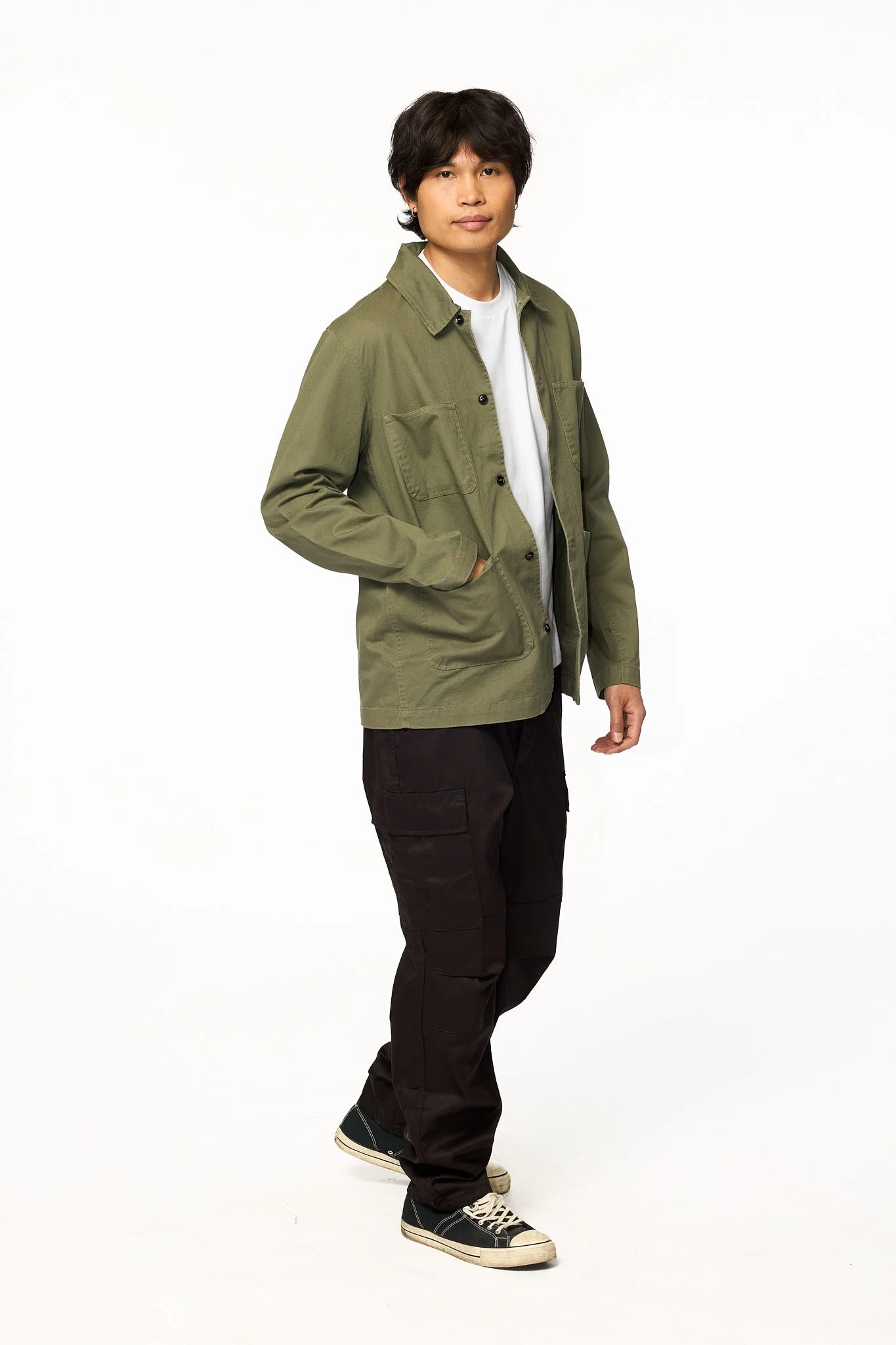 Green chore jacket worn with casual outfit shown in walking pose for everyday styling