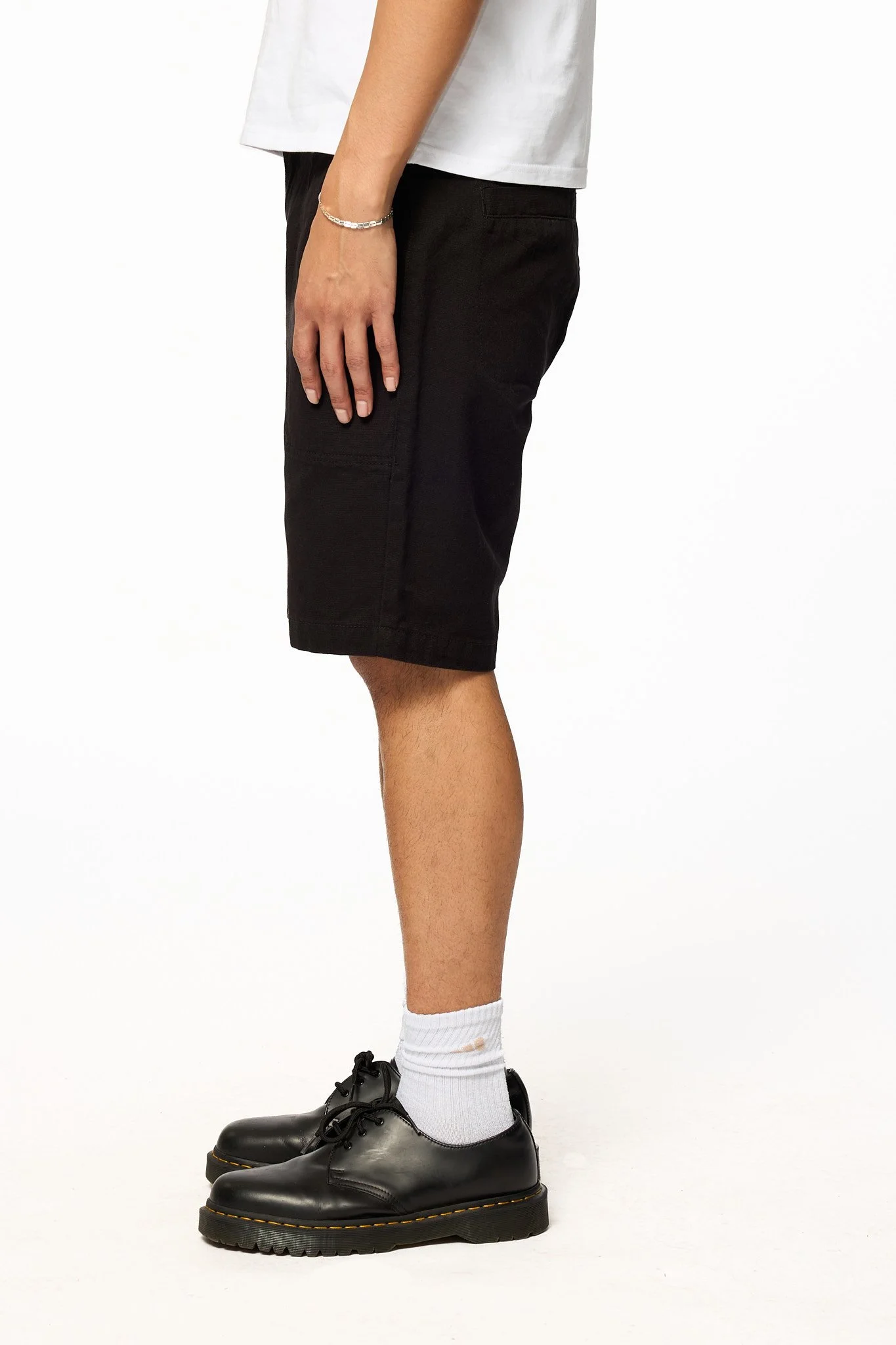 Brown canvas work shorts side detail showing pocket construction and stitching