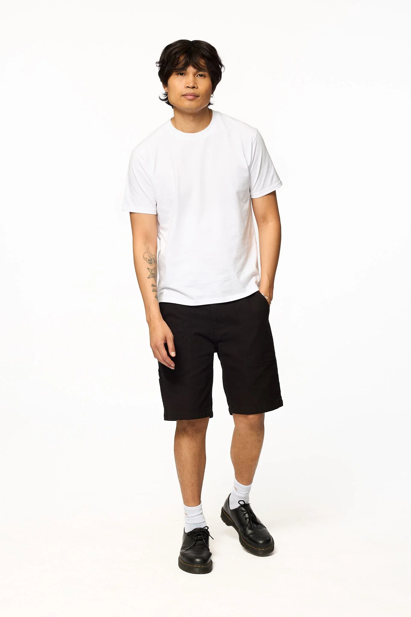 Black canvas work shorts by The SellOut full body walking view showing relaxed fit