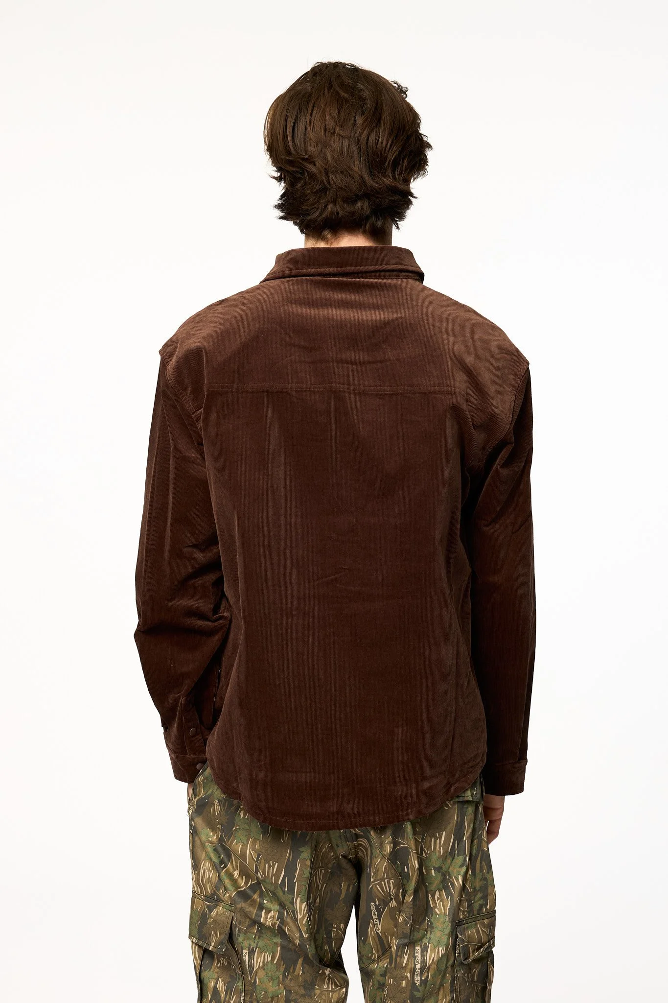 Oversized brown corduroy shirt jacket back view showing relaxed fit