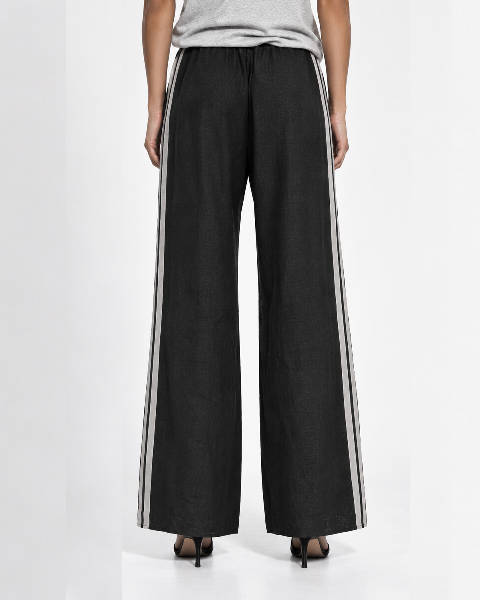 Back view of The SellOut black cotton-linen wide-leg track pants with double light-gray side tape.