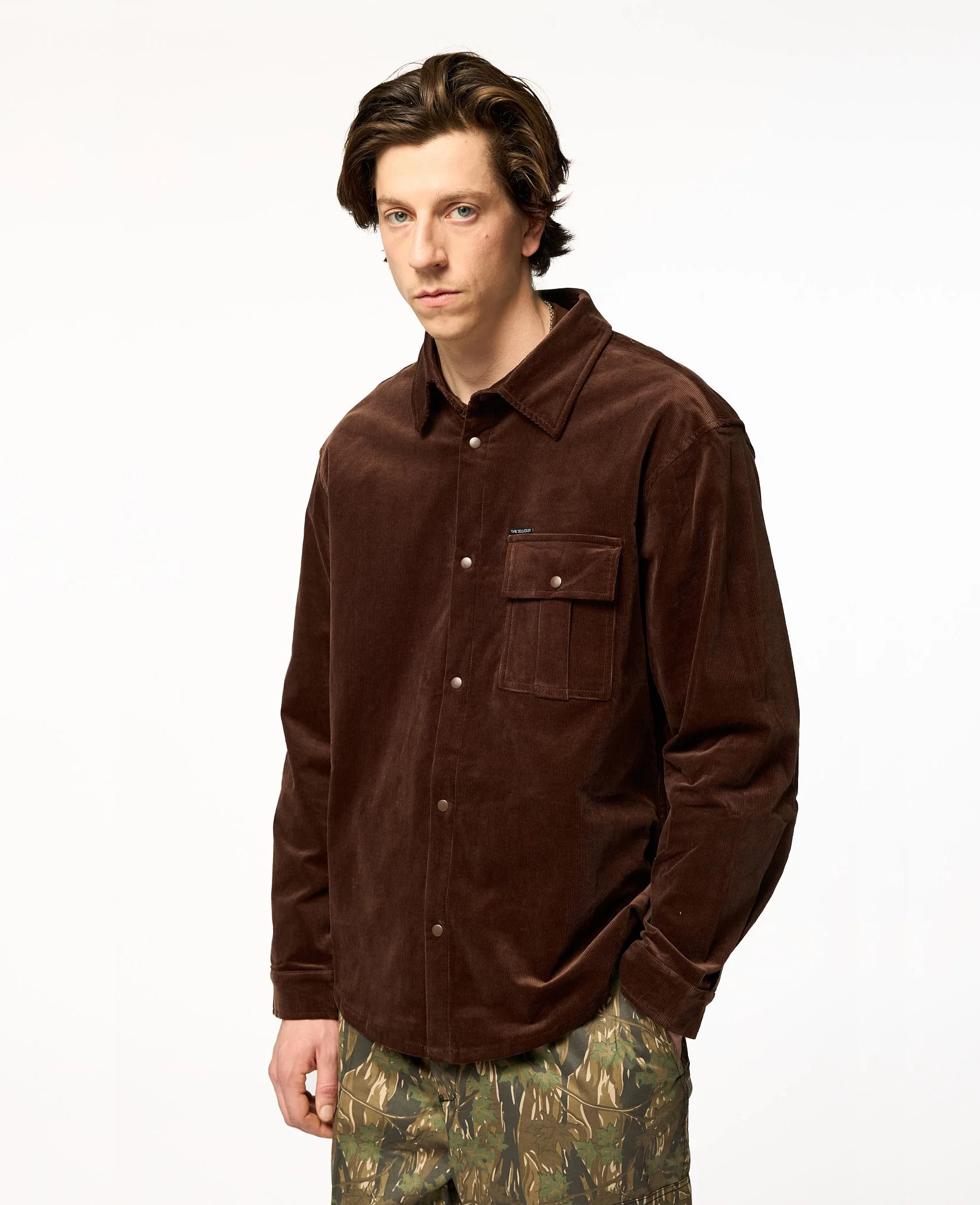Oversized brown corduroy shirt jacket side 3/4 view showing relaxed fit
