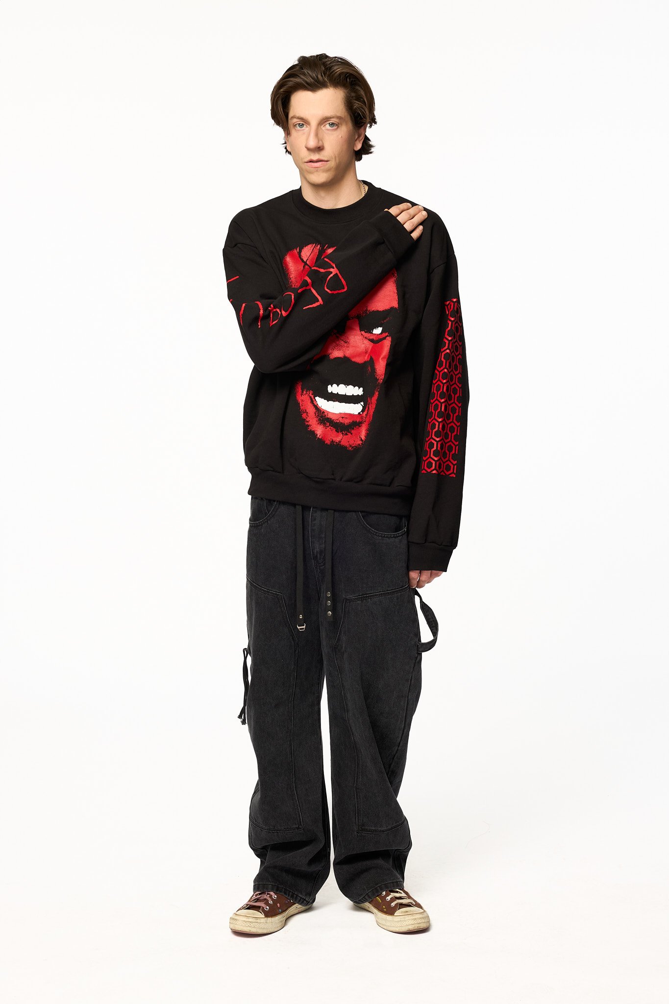 Black The Shining crewneck sweatshirt close-up showing red horror face graphic and print detail
