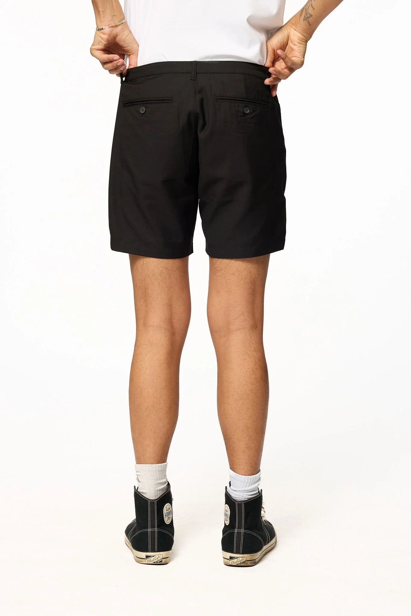 Black piped shorts back view showing rear pockets and structure