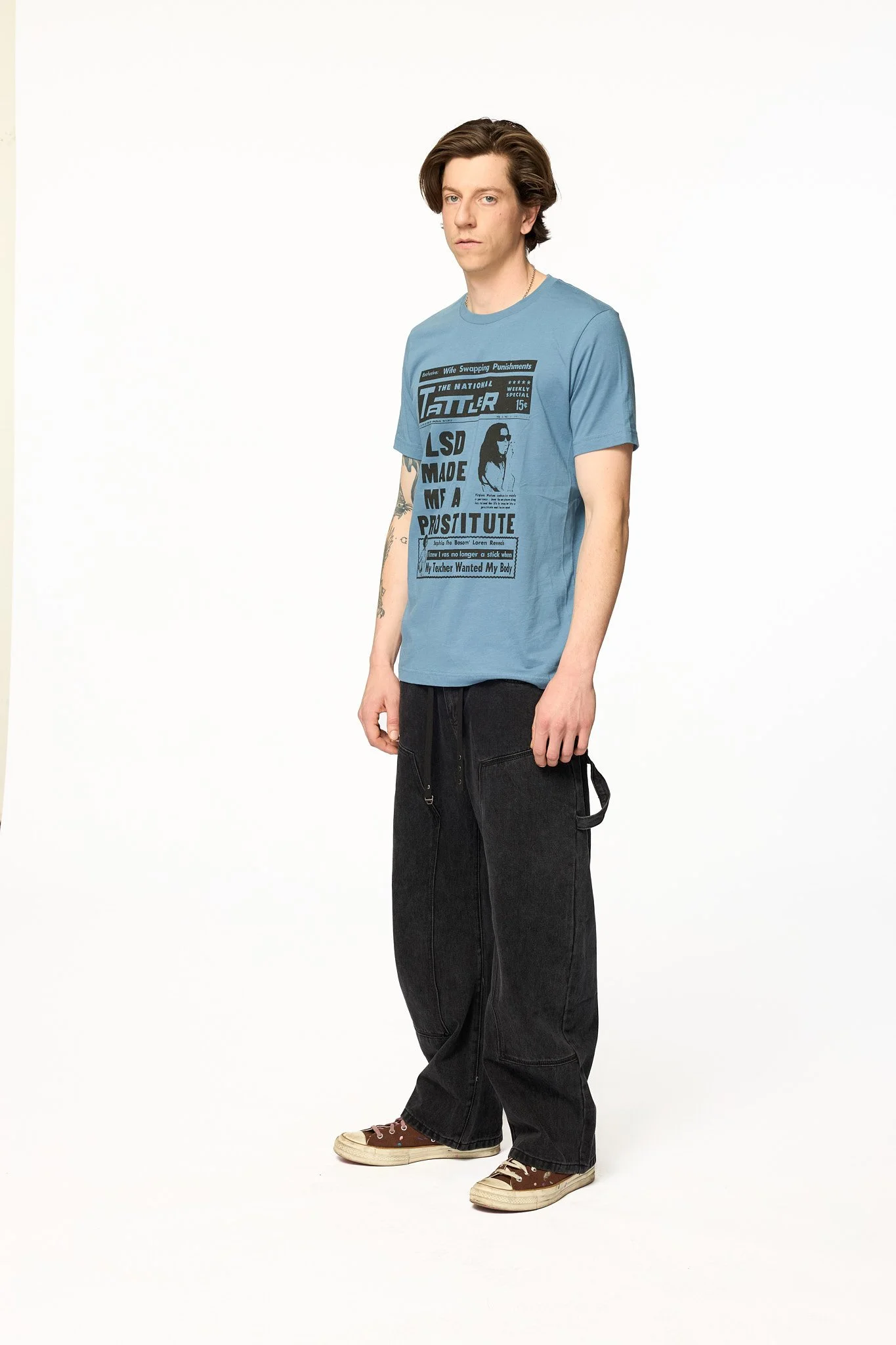 Blue Tattler graphic t-shirt full body walking showing tabloid style print and relaxed fit