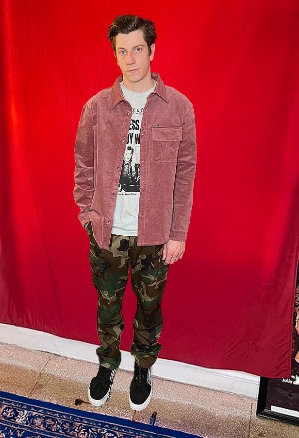 Model wearing Corduroy Shirt Jacket in olive green paired with woodland camo pants in streetwear styling.