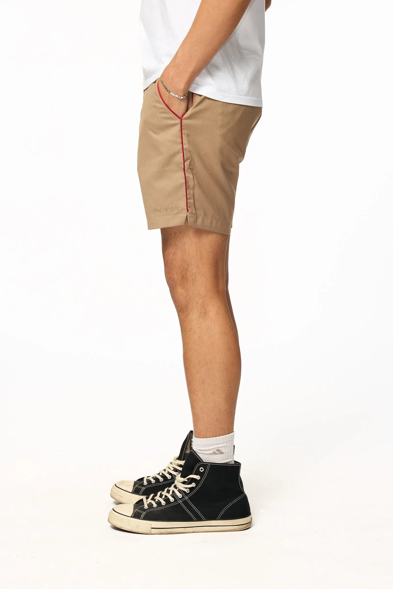 Khaki piped shorts side view showing red contrast piping detail